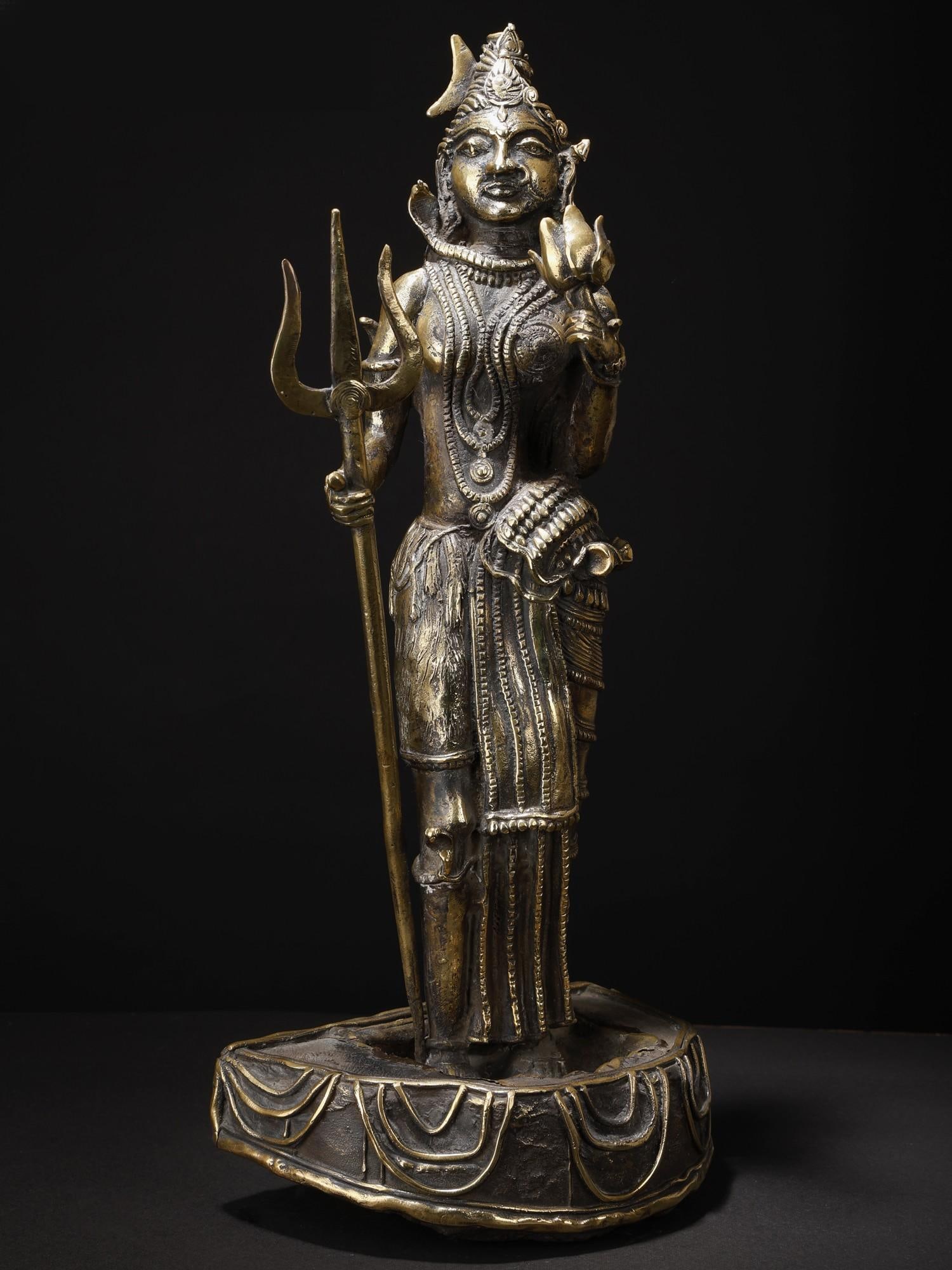 19" Ardhanarishvara (Shiva - Shakti) Brass and Stone Sculpture: Title: 19" Ardhanarishvara (Shiva - Shakti) Brass and Stone Sculpture Description: Simple in make and sophisticated in meaning, this brass and stone sculpture of Ardhanarishwara holds within its aesth