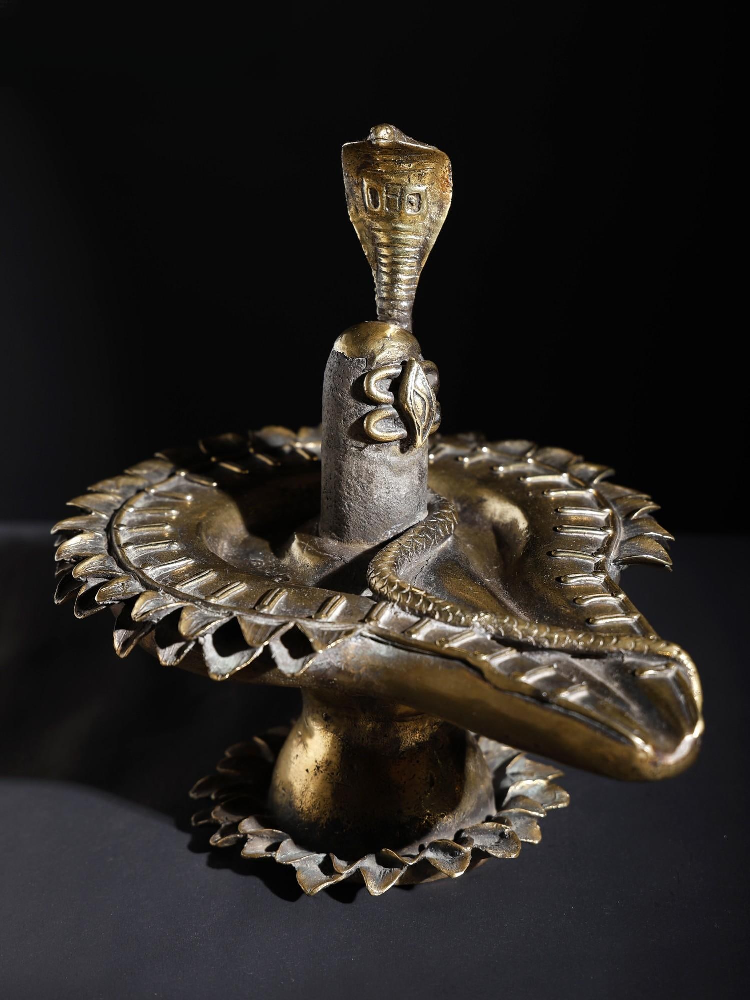 9" Shiva Linga with Protecting Naag | Original Sculpture: Title: 9" Shiva Linga with Protecting Naag | Original Sculpture Description: Additional Information: Brass Statues Reserve: $337.00 Shipping: Domestic: Flat-rate of $37.00 to anywhere within the conti
