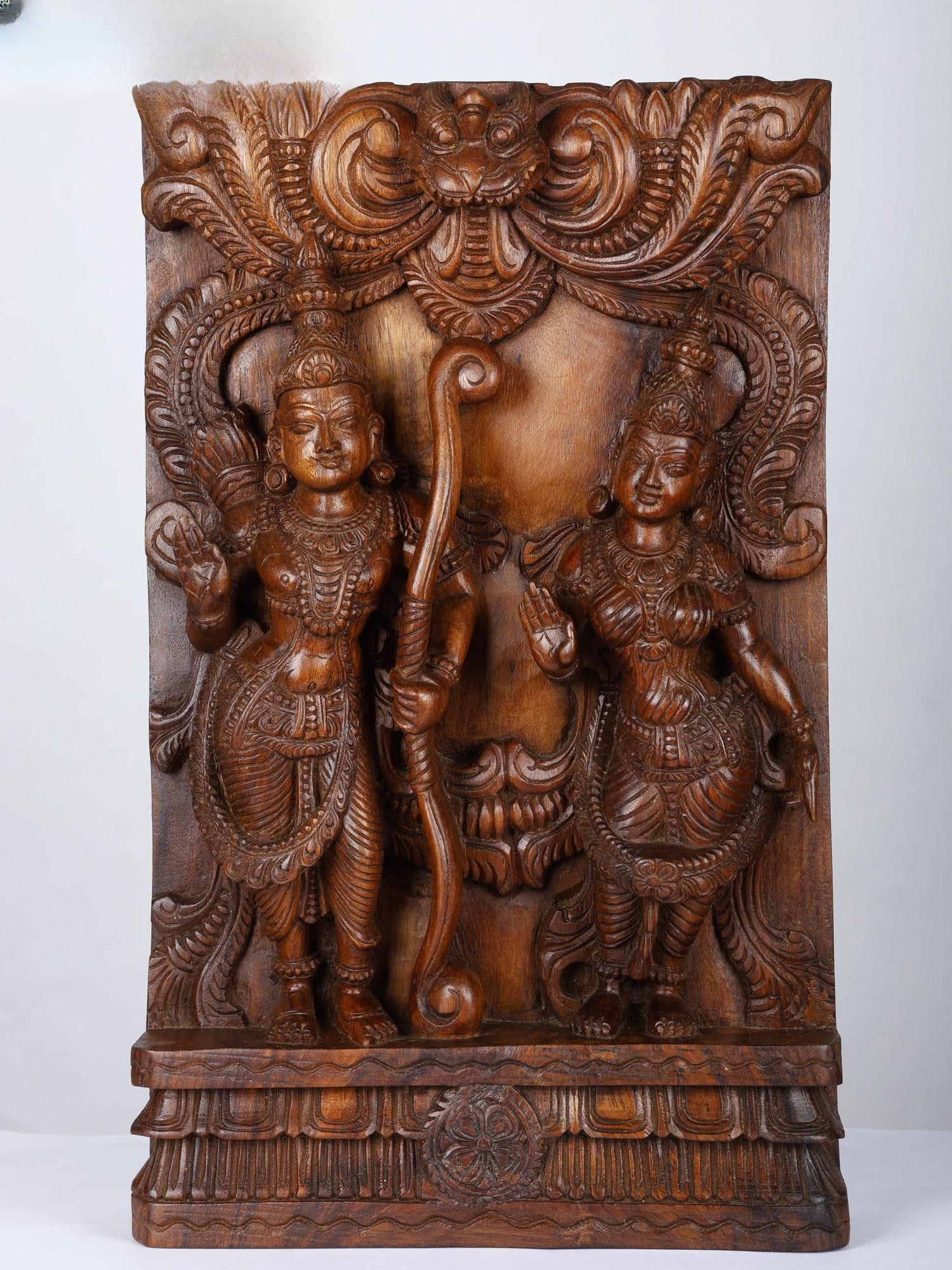 24" Blessing Siya-Rama Wood Carved Statue: Title: 24" Blessing Siya-Rama Wood Carved Statue Description: This wood-carved statue on the rectangular wooden plank portrays an enchanting scene of Blessing Siya-Rama, capturing the divine union of 