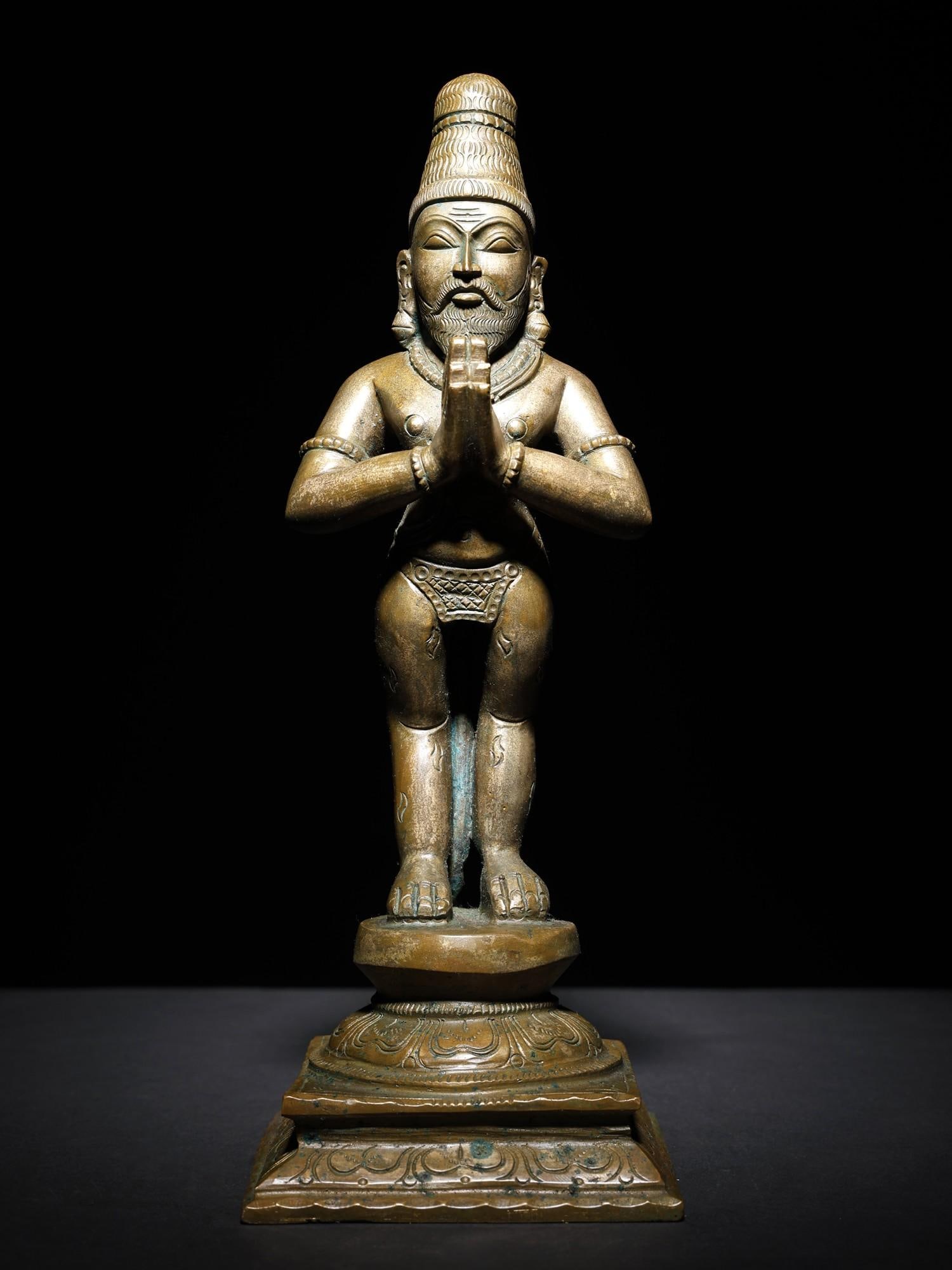 12" Nayanara Saint Vyaghrapada Bronze Statue: Title: 12" Nayanara Saint Vyaghrapada Bronze Statue Description: His hands are in Anjali Mudra and his feet are shaped like the feet of a tiger, the bewildering saint in this bronze is Vyaghrapada