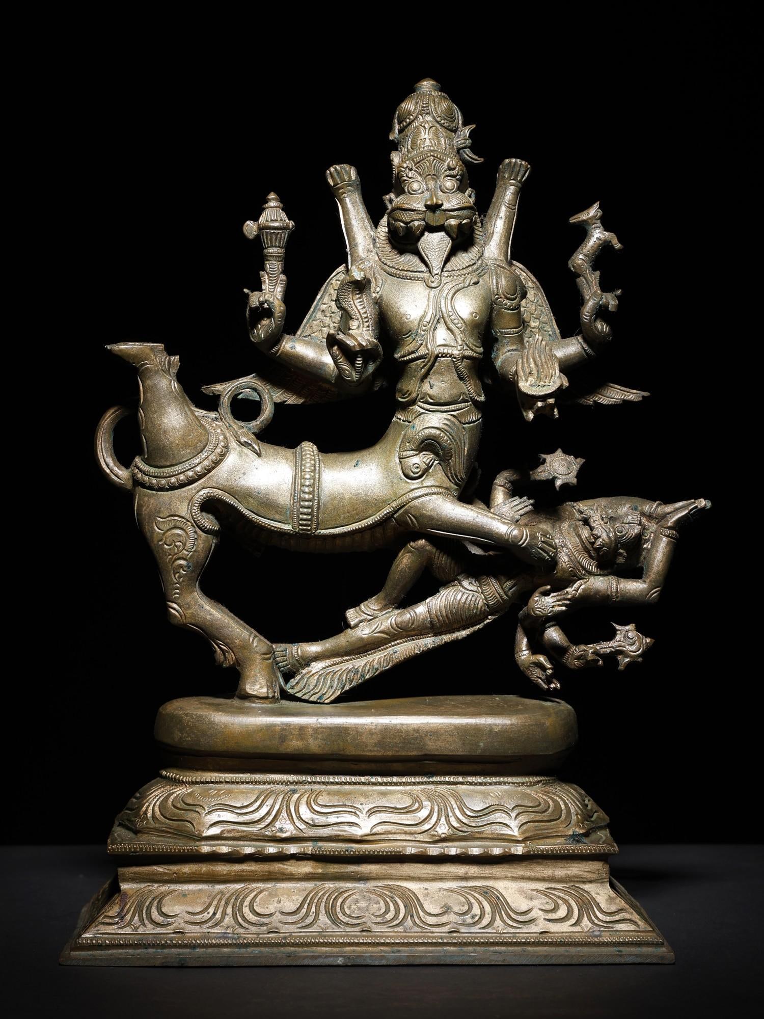 13" Lord Shiva as Sharabha Subduing Narasimha | Bronze Statue: Title: 13" Lord Shiva as Sharabha Subduing Narasimha | Bronze Statue Description: Sharabheshvaramurti is a Lila of Shiva revered in Hindu texts and art, where the Lord of Destruction took upon the tas