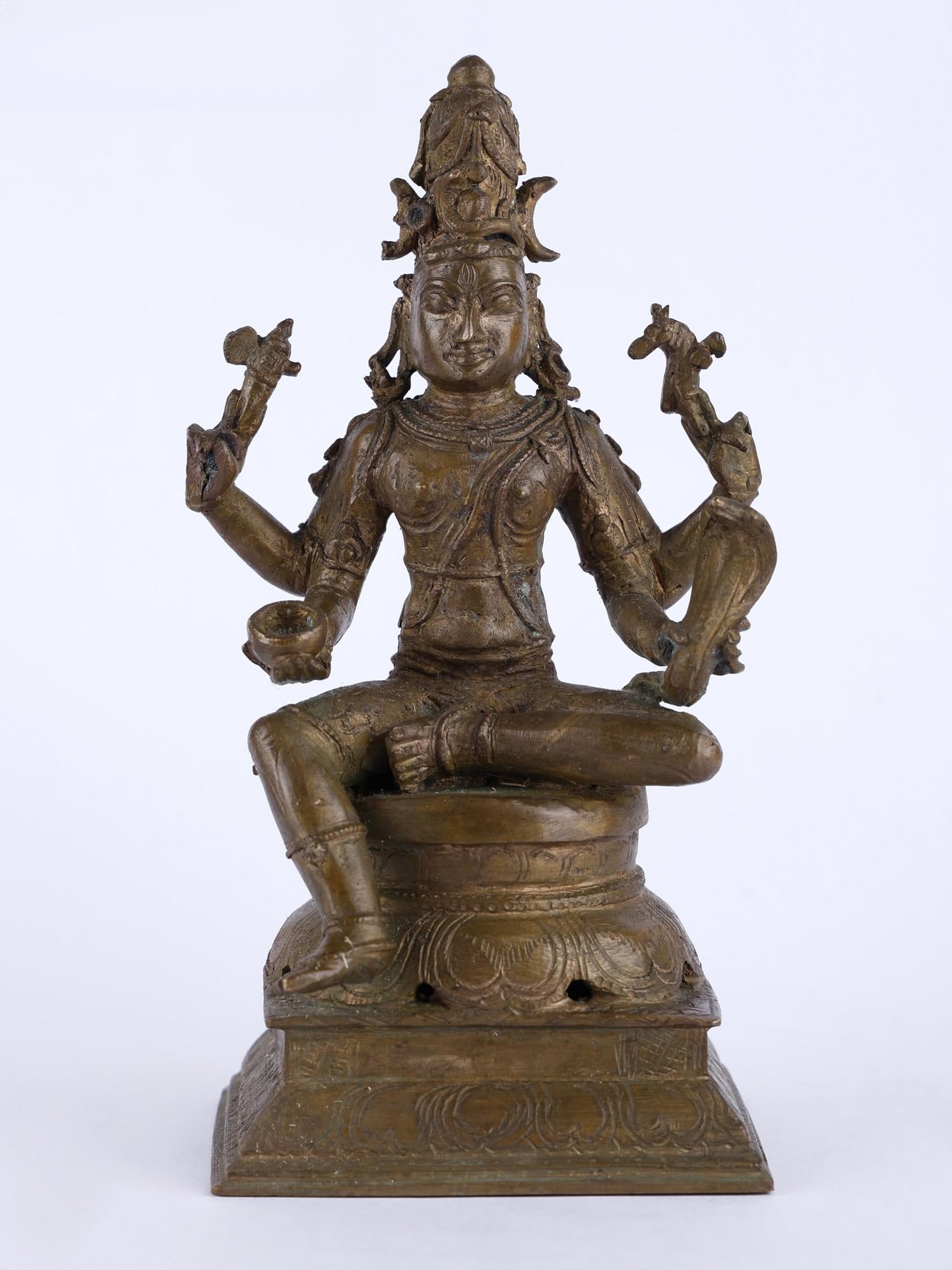 7" Lord Shiva as Vishapaharana Bronze Statue: Title: 7" Lord Shiva as Vishapaharana Bronze Statue Description: The bronze statue is a striking representation of one of the most revered forms of Lord Shiva, showcasing his role as the destroyer of