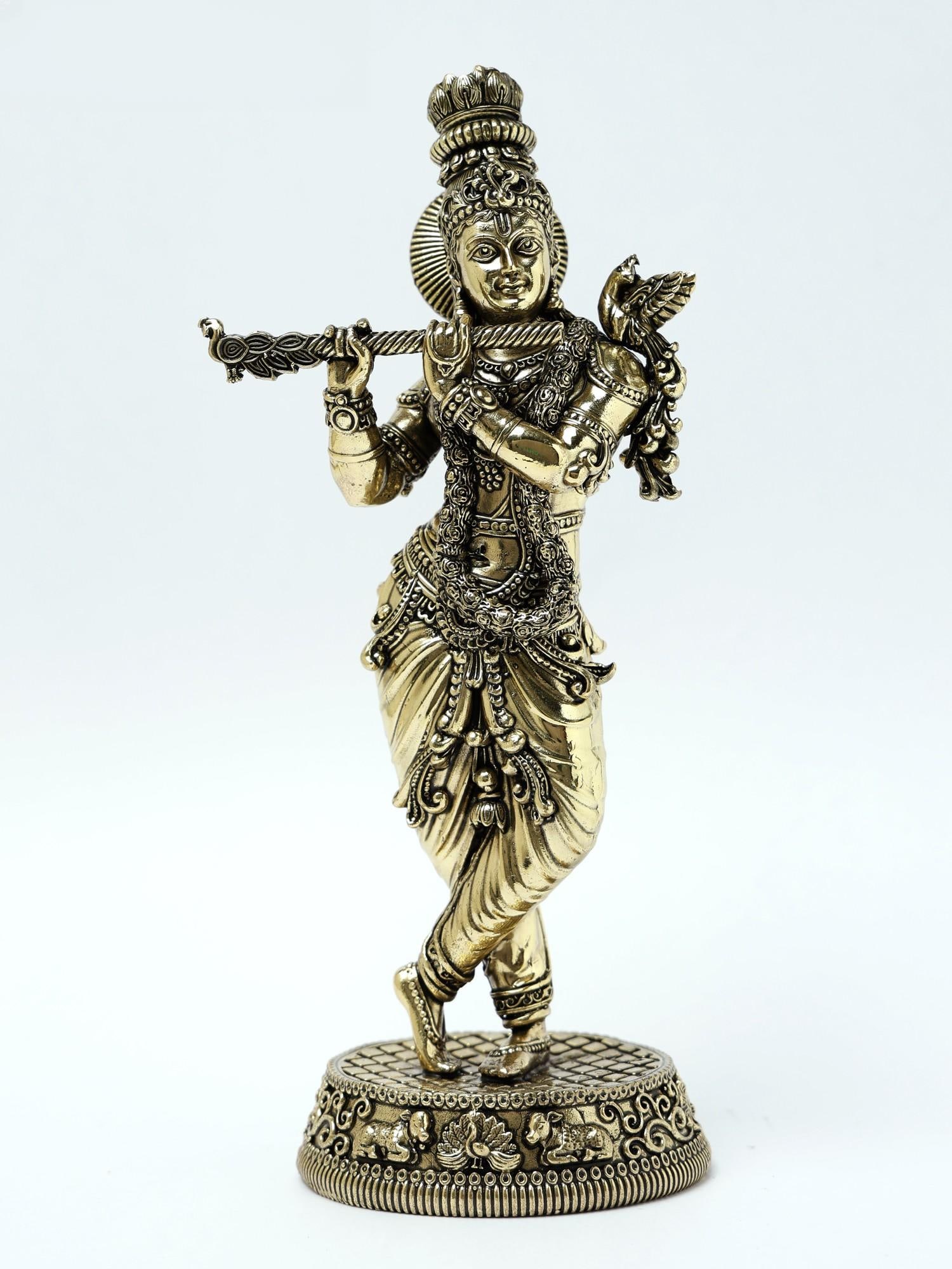 9" Superfine Lord Krishna Brass Statue Playing Flute: Title: 9" Superfine Lord Krishna Brass Statue Playing Flute Description: This Brass Statue of Lord Krishna playing the flute and standing in the Tribhanga pose is a captivating representation of the
