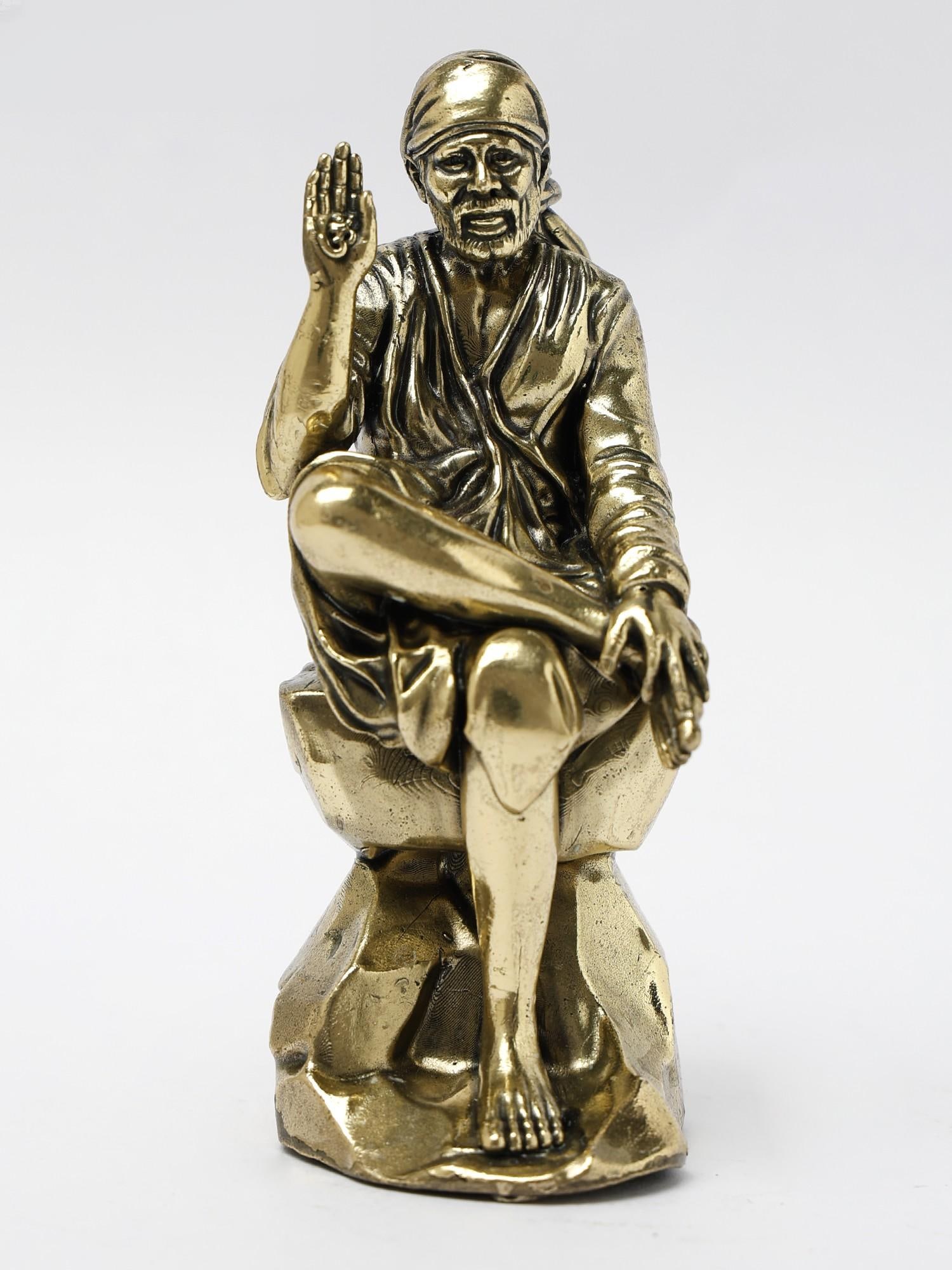 5" Small Blessing Sai Baba Brass Statue: Title: 5" Small Blessing Sai Baba Brass Statue Description: The brass statue of Small Blessing Sai Baba is a sacred representation of the revered Indian saint. Sai Baba, known for his teachings of