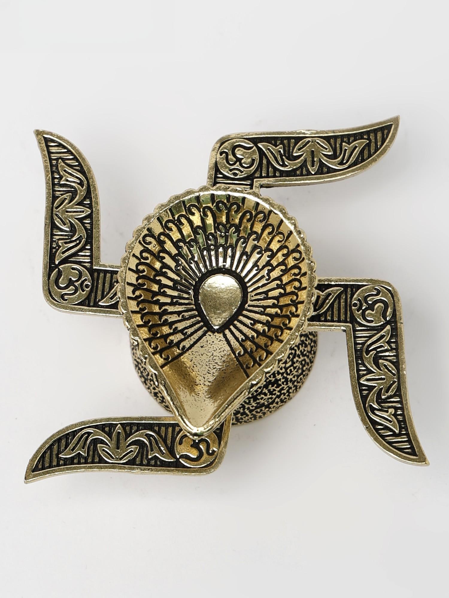 2" Small Swastik Diya in Brass: Title: 2" Small Swastik Diya in Brass Description: This Small Swastik Diya in Brass is a stunning piece, exuding traditional charm and spiritual significance. Its unique design features a leaf-shaped