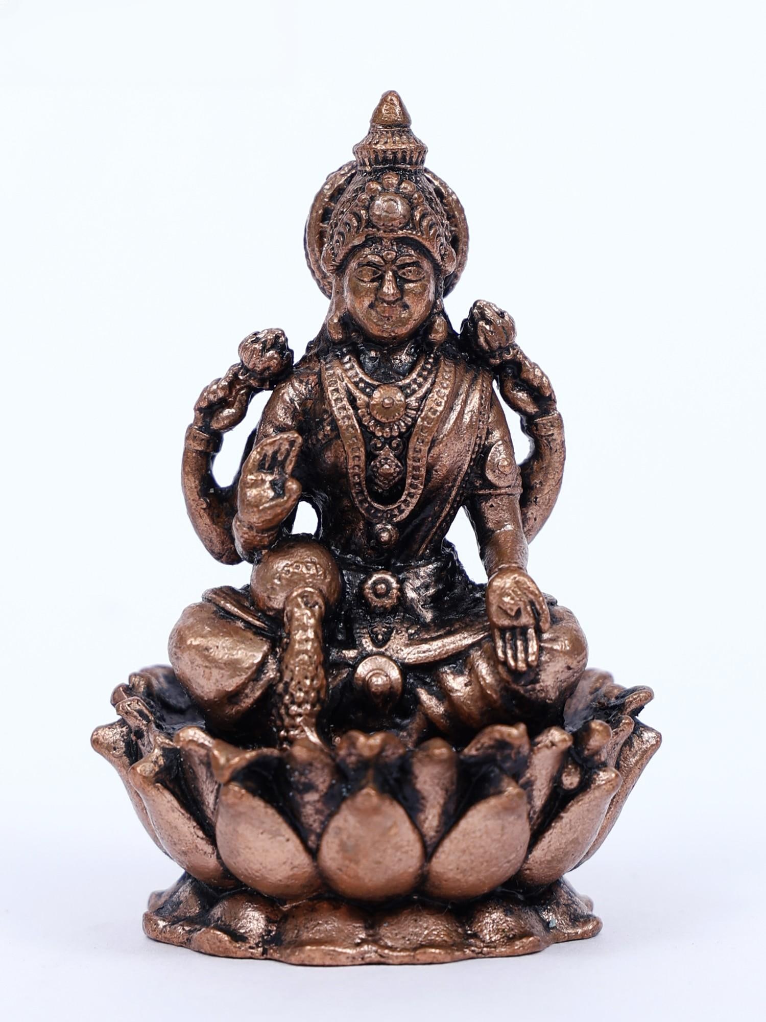 Small Blessing Goddess Lakshmi Copper Statue Seated on Lotus: Title: Small Blessing Goddess Lakshmi Copper Statue Seated on Lotus Description: With the purest goddess, Lakshmi, seated on a lotus, enter the ethereal realm of celestial riches. Made from lustrous c