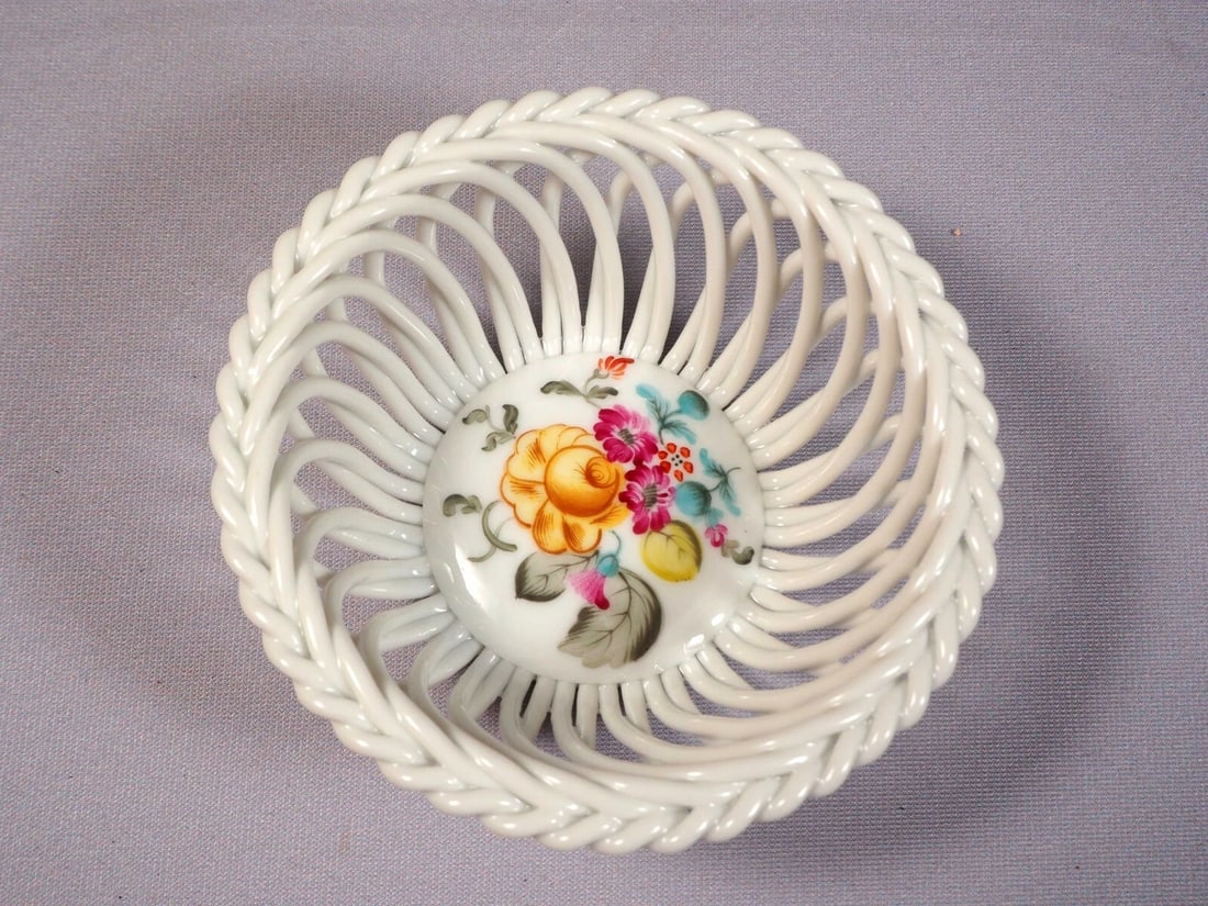 Herend Hungary Lichtenstein Garden Multicolor Woven Basket Trinket Dish: This is an exceptional Porcelain wave basket made by Herend in Hungary in their most famous and rare Lichtenstein Garden pattern. The basket is are with Herend backstamp and 7373/LT. I think the LT co