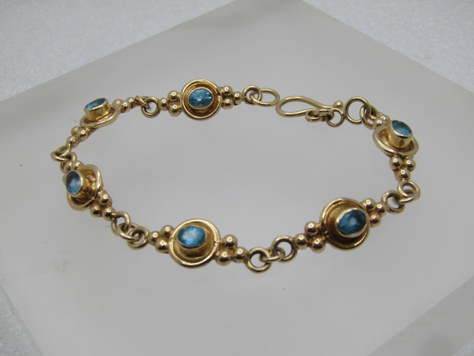 Vintage 14kt Blue Topaz Custom-Made Bracelet, 7.5", 1980's: Title:Vintage 14kt Blue Topaz Custom-Made Bracelet, 7.5", 1980's Description:Vintage 14kt Blue Topaz Custom-Made Bracelet, 7.5", 1980's. Six links each with a blue topaz bezel-set oval stone set highe