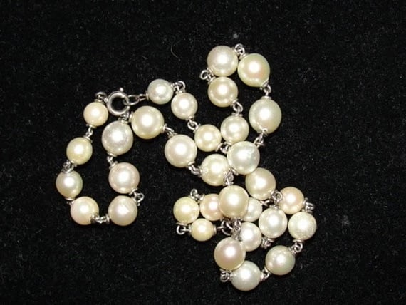 Sterling Silver Cultured Pearl Bead Necklace: Title:Sterling Silver Cultured Pearl Bead Necklace Description:Great hand made cultured pearl necklace. Made with sterling silver cord woven through each pearl. Closes with a sterling silver clasp