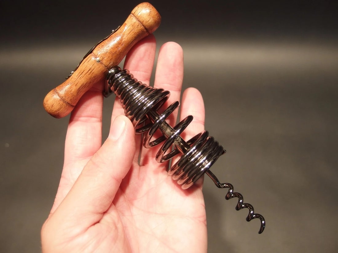 Spring Assisted Direct Pull Corkscrew Wine Bottle Opener: 6 1/8" Long x 3 1/2" Wide Great reproduction spring assisted direct pull corkscrew. This piece has a paper clip type retainer and a spring incorporated to assist removing the cork. Was made to look ju