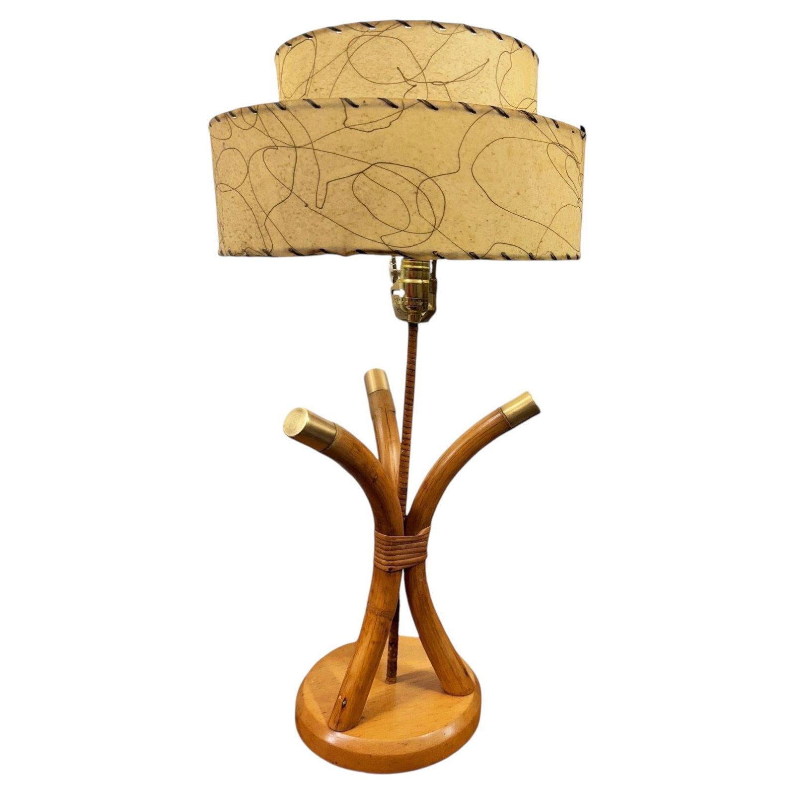 Restored Hourglass Palm Shaped Rattan & Mahogany Lamp w/ Whipple Stitch Shade: Title: Restored Hourglass Palm Shaped Rattan & Mahogany Lamp w/ Whipple Stitch Shade Description: Restored pair of three-strand scalloped rattan bent pole table lamps on a mahogany base with brass cen