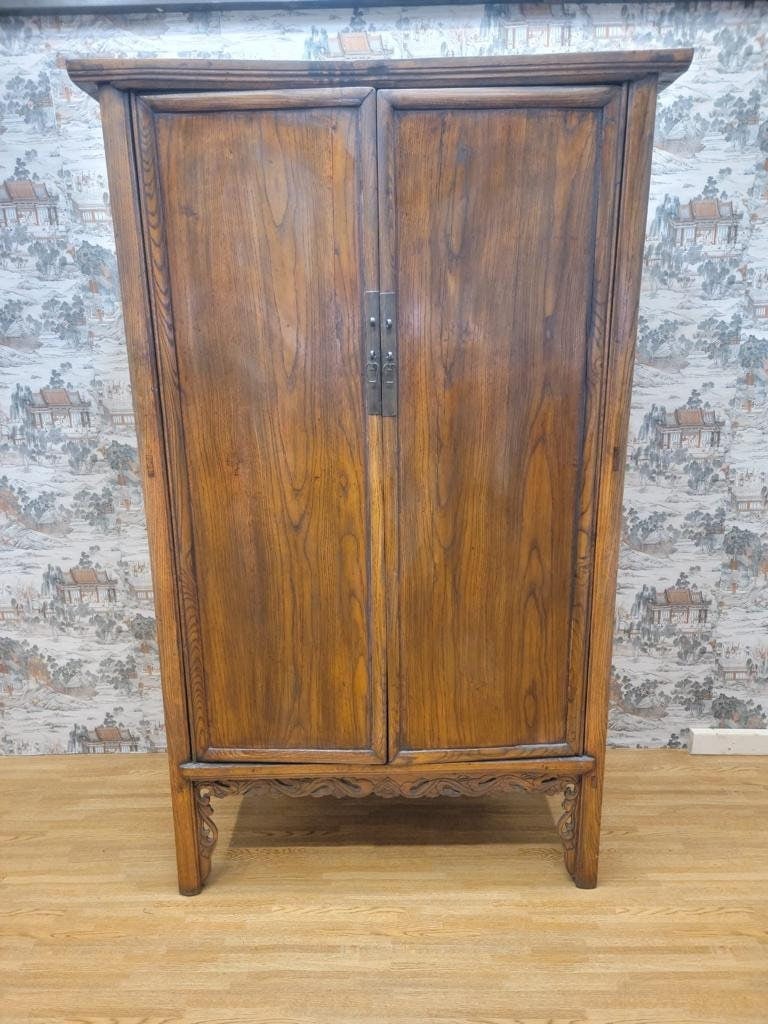 Antique Shanxi Province Armoire Highboy Storage Cabinet: Materials: elm, brass, wood, metalWidth: 47.5 inchesHeight: 84 inchesDepth: 20.5 inches.Antique Shanxi Province Armoire Highboy Storage CabinetThis authentic early 20th-century cabinet from