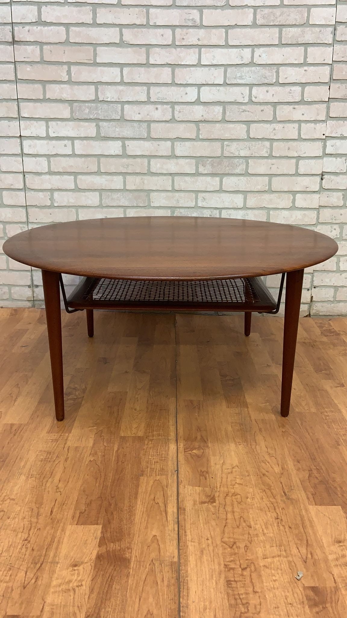 Vintage Danish France and Son Teak and Rattan Coffee Table: Vintage from the 1960sMaterials: wood, Teak, rattanWidth: 39 inchesHeight: 17.5 inchesDepth: 39 inchesVintage Danish France & Son Teak Coffee Table with Rattan Lower ShelfThis is a beautiful round