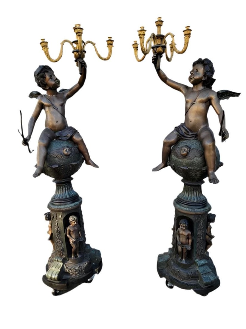Vintage Victorian Style Winged Cherub Candelabra Bronze Statues - Set of 2: Materials: bronze, metalAntique Victorian Style Winged Cherub Candelabra Bronze Floor Statues - PairEach sculpture depicts a cupid-winged cherub upon figural winged cherub with acanthus foliate