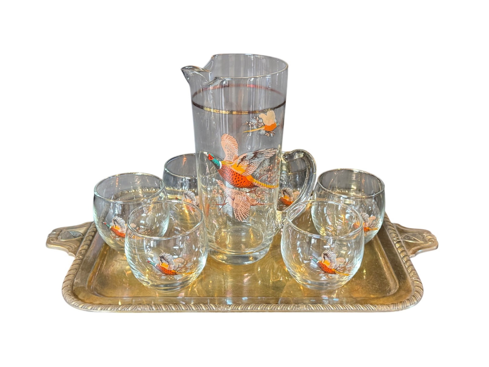 Vintage Pheasant-Decorated Glass Pitcher and Tumbler Set: This charming vintage glass beverage set features a pitcher and six matching tumblers, all adorned with colorful pheasant motifs. The pitcher also has delicate gold band accents. Likely mid-20th