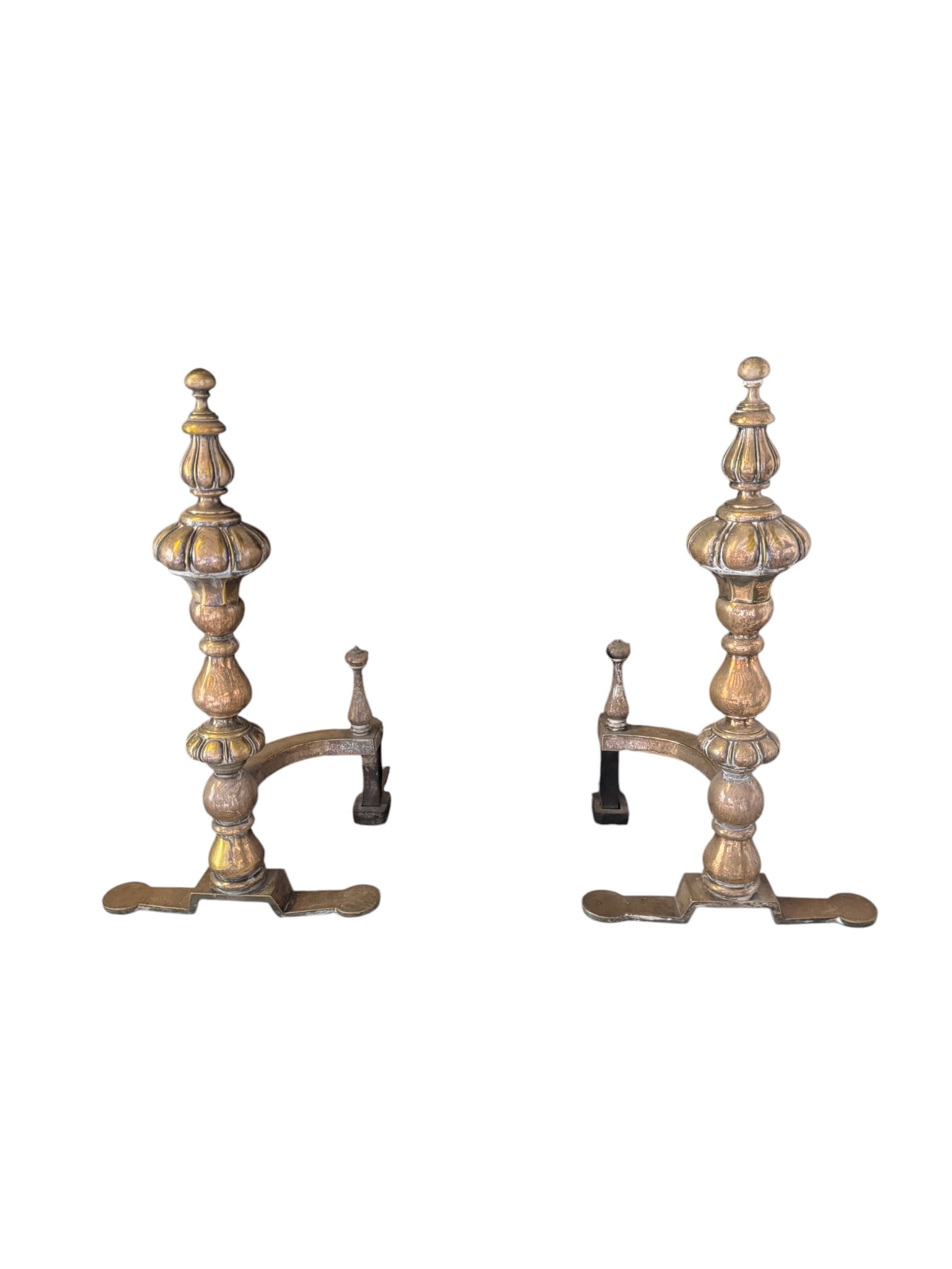 Pair of Ornate Brass Fireplace Andirons: A pair of ornate brass fireplace andirons, likely from the late 19th or early 20th century, featuring highly decorative turned and carved forms. The style suggests a revival of earlier classical or