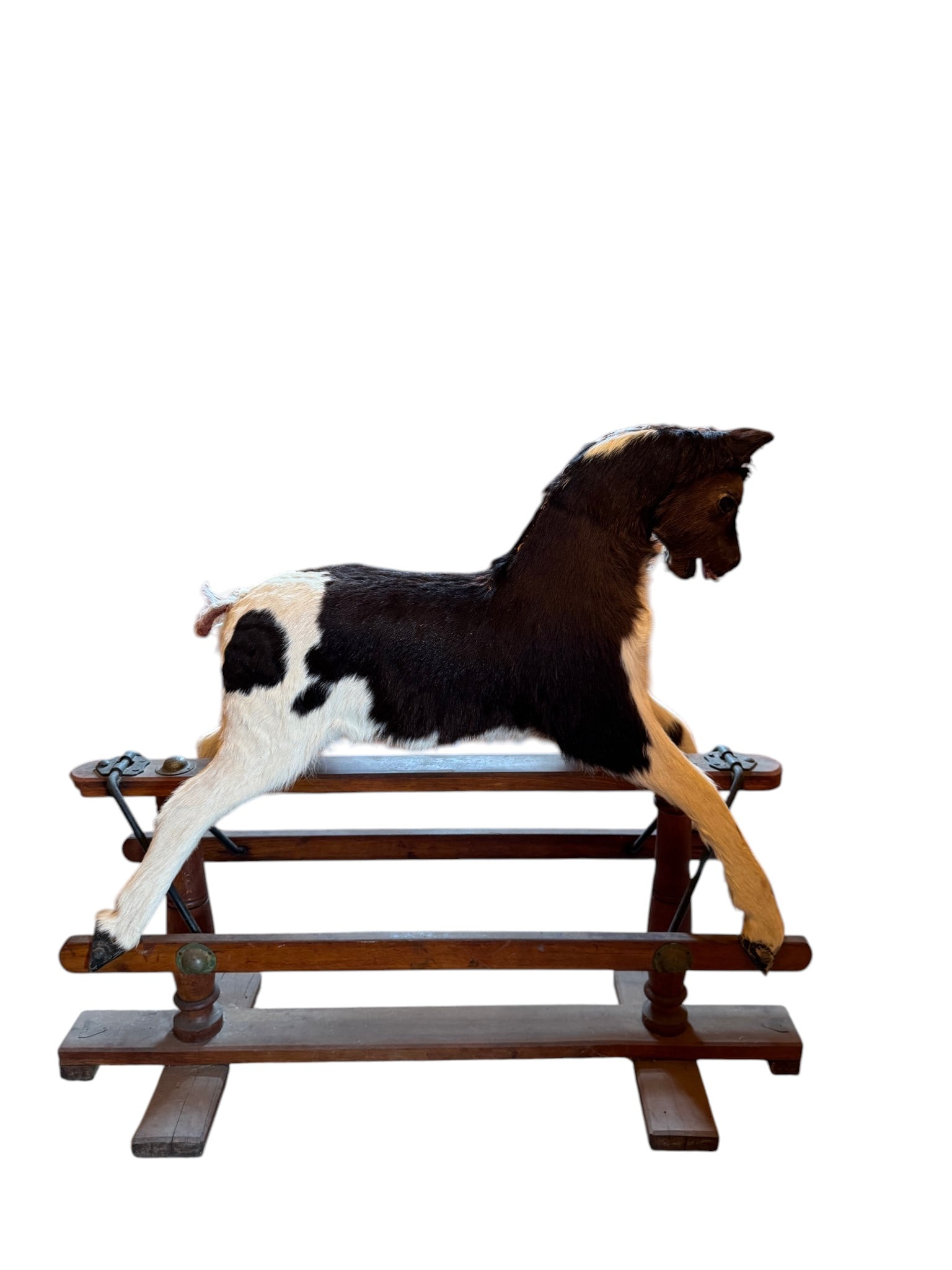 Vintage Hair on Hide Rocking Horse: A vintage hair on hide rocking horse. The piece captures a moment of playful or alert animation, making it a distinctive decorative item. The style suggests a rustic, possibly early 20th-century folk