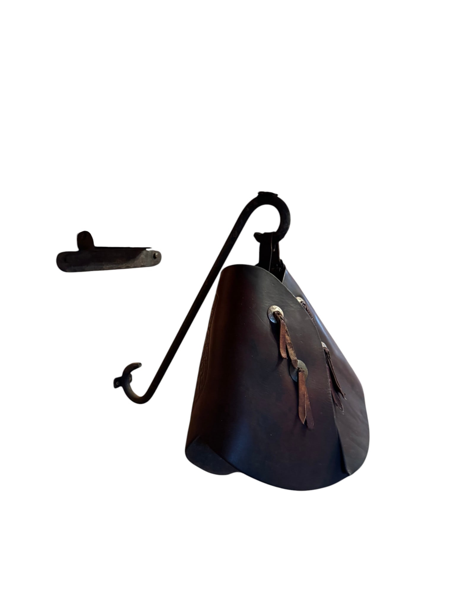Hand-Tooled Leather Western Stirrup Covers: This traditional Western stirrup covers features hand-tooled leather with intricate floral and scrollwork designs, indicative of a mid-20th century Western style. The rich brown leather is accented