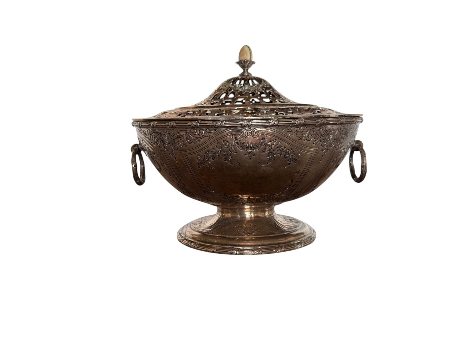 An Ornate Gorham Sterling Silver Footed Centerpiece Bowl with Reticulated Lid, Likely 19th Century: This ornate sterling silver footed centerpiece bowl features a beautifully chased and engraved body with scrolling floral and foliate motifs. The elegant form is complemented by two delicate ring hand
