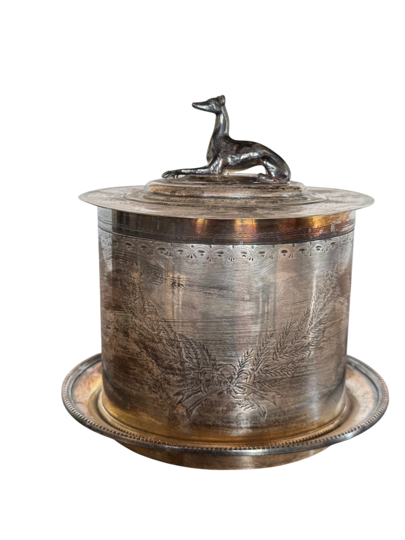 W.F. & J.C. Stubbs Sterling Silver Box with Greyhound Finial: A sophisticated sterling silver box by W.F. & J.C. Stubbs, likely dating to the early 20th century. The cylindrical body features intricate etched botanical scrollwork and a finely detailed border