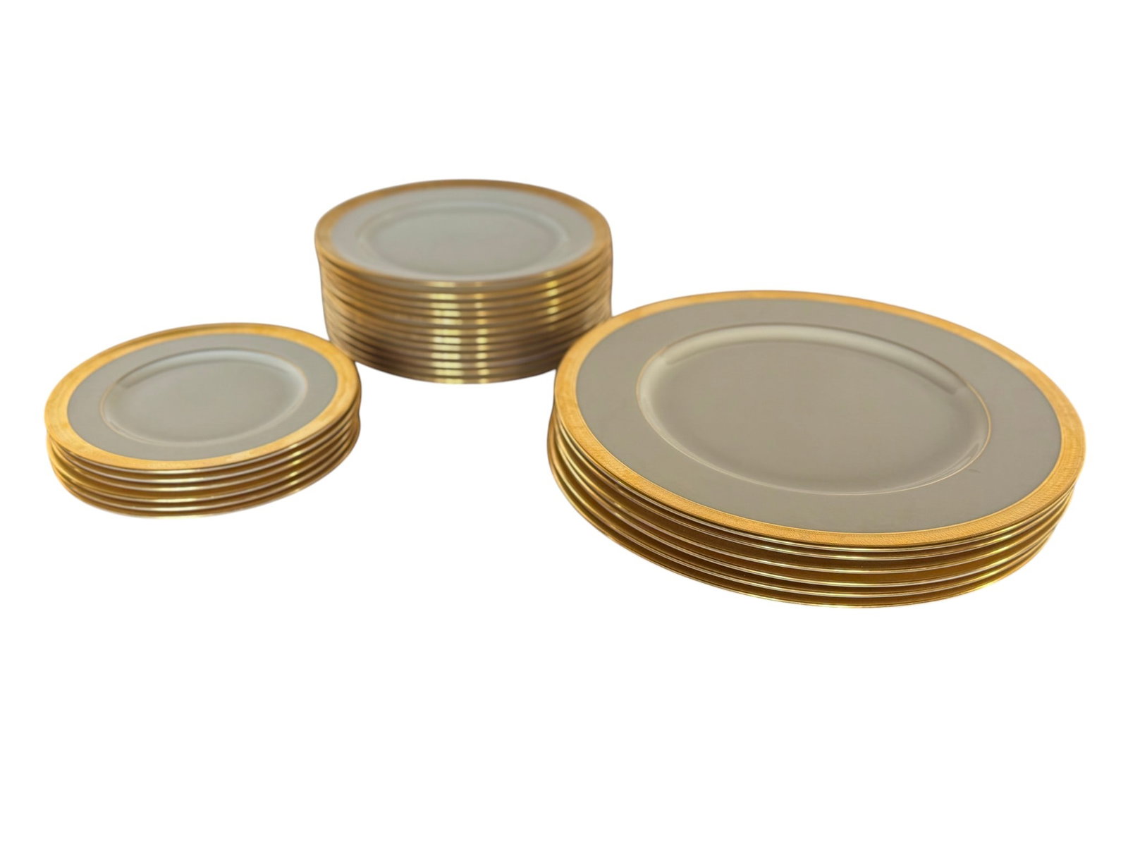 Set of Lowell by Lennox Dinnerware: A comprehensive set of Lowell by Lennox pattern dinnerware. This elegant set features a classic design with a soft cream-colored ground, bordered by a tasteful gold band embellished with a subtle