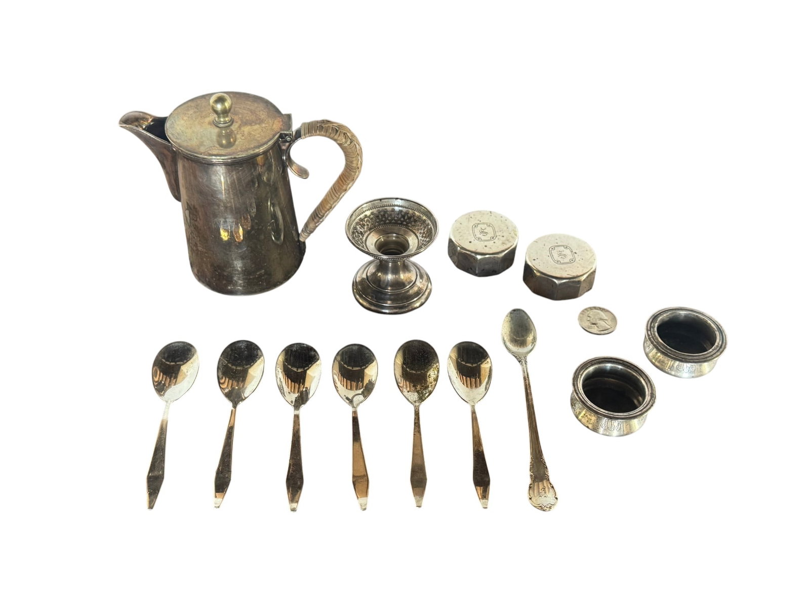 Collection of Sterling Silver Tableware with Coffee Pot, Spoons, Boxes, and Napkin Rings: A charming collection of sterling silver tableware featuring a small coffee pot with an ornate handle, six matching spoons, two small hexagonal lids with "S" monograms, a candle holder, and two salt