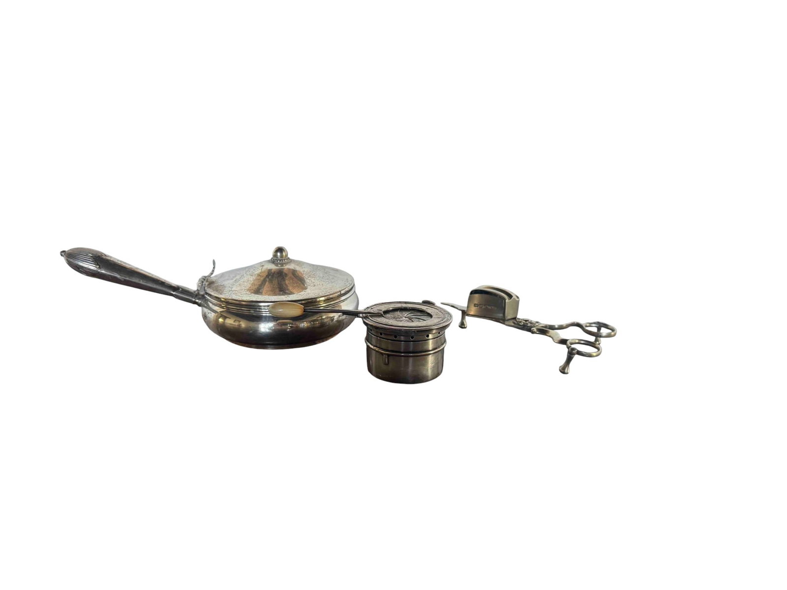 Three-Piece Sterling Silver Silent Butler, Oil Lamp and Candle Wick Trimmer: This refined three-piece sterling silver pieces includes a silent butler with an articulated handle, an oil lamp with an ivory handle, and wick trimmer scissors. The tea caddy features a classic, mini