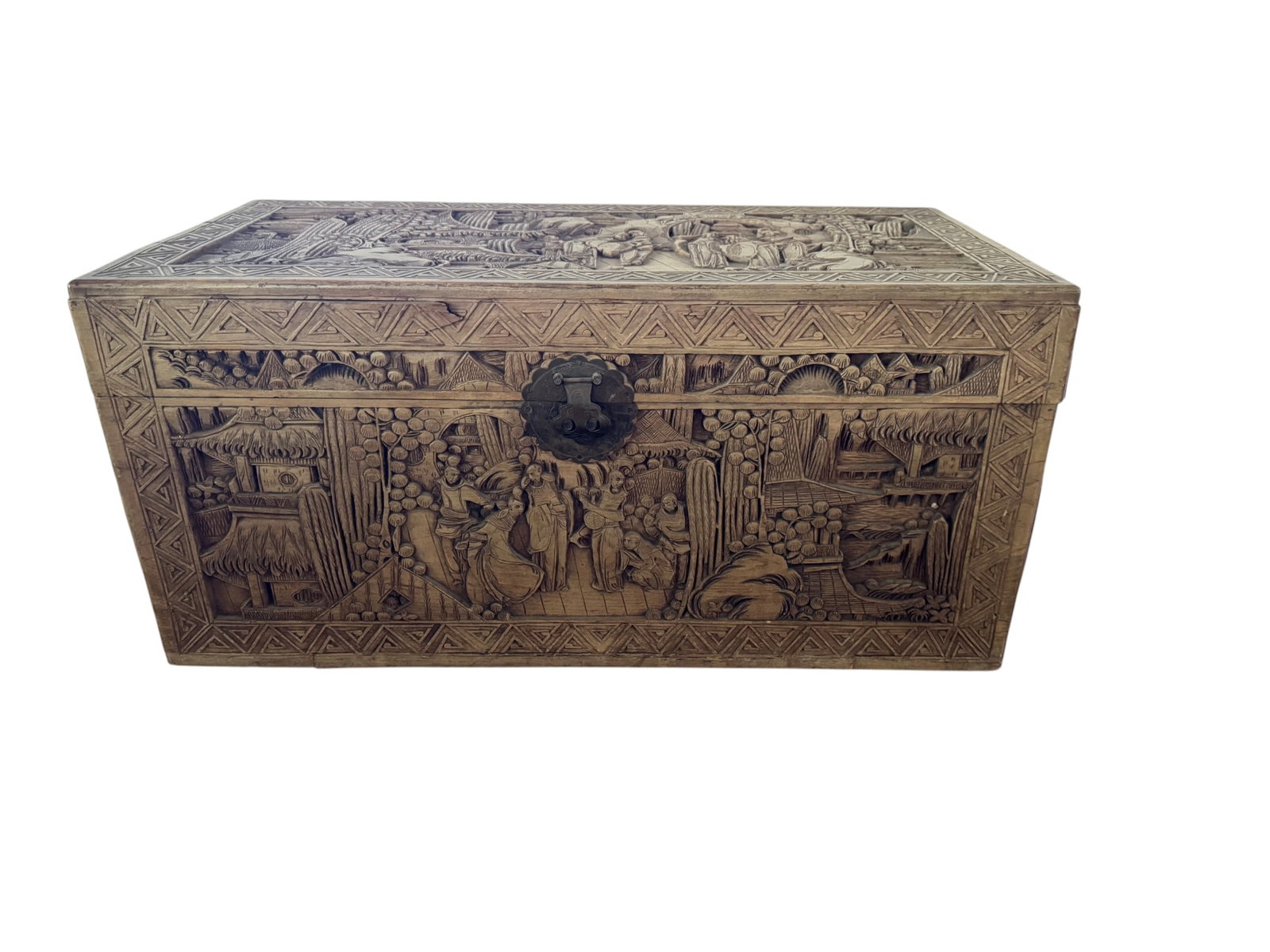 Carved Camphor Wood Trunk: This meticulously carved camphor wood trunk features intricate figural and landscape scenes on all visible sides and the lid. The detailed carvings depict traditional Chinese characters in various