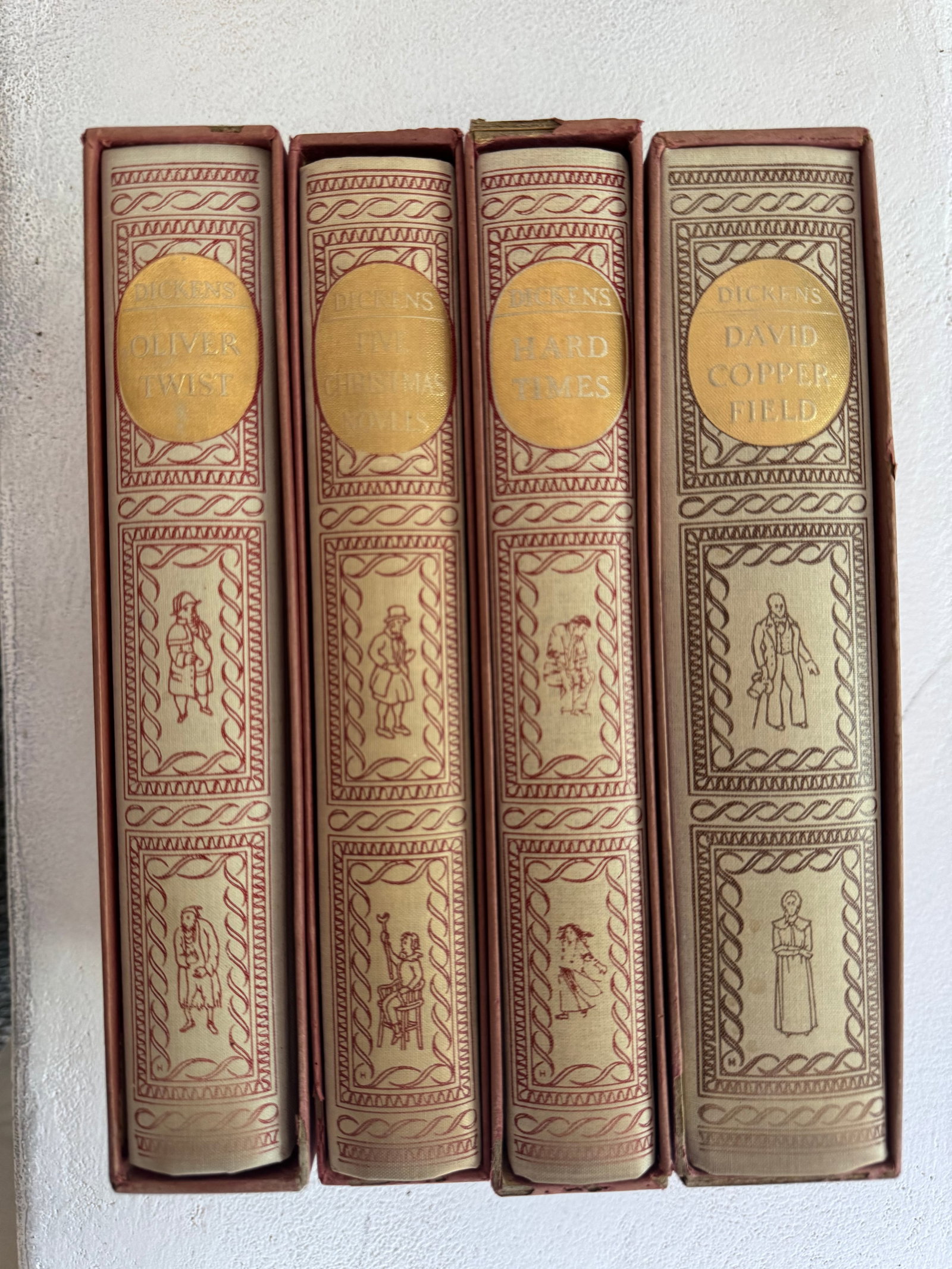 Set of Four Charles Dickens Novels with Decorative Slipcovers, Heritage Press Edition: A charming set of four classic novels by Charles Dickens, published by The Heritage Press: "David Copperfield," "Hard Times," "Christmas Carol," and "Oliver Twist." Each book is bound in light tan