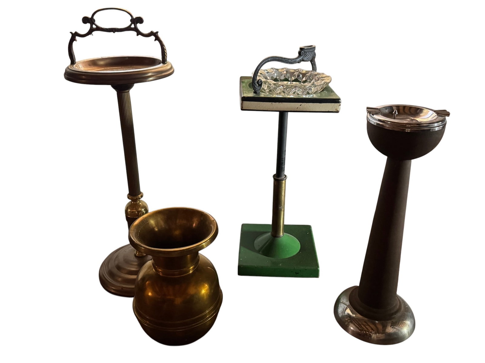 Collection of Vintage Smoking Stands and Brass Vase: This lot features a collection of vintage smoking accessories and a decorative brass vase. The first item is a brass smoking stand with an ornate handle, likely from the early to mid-20th century.