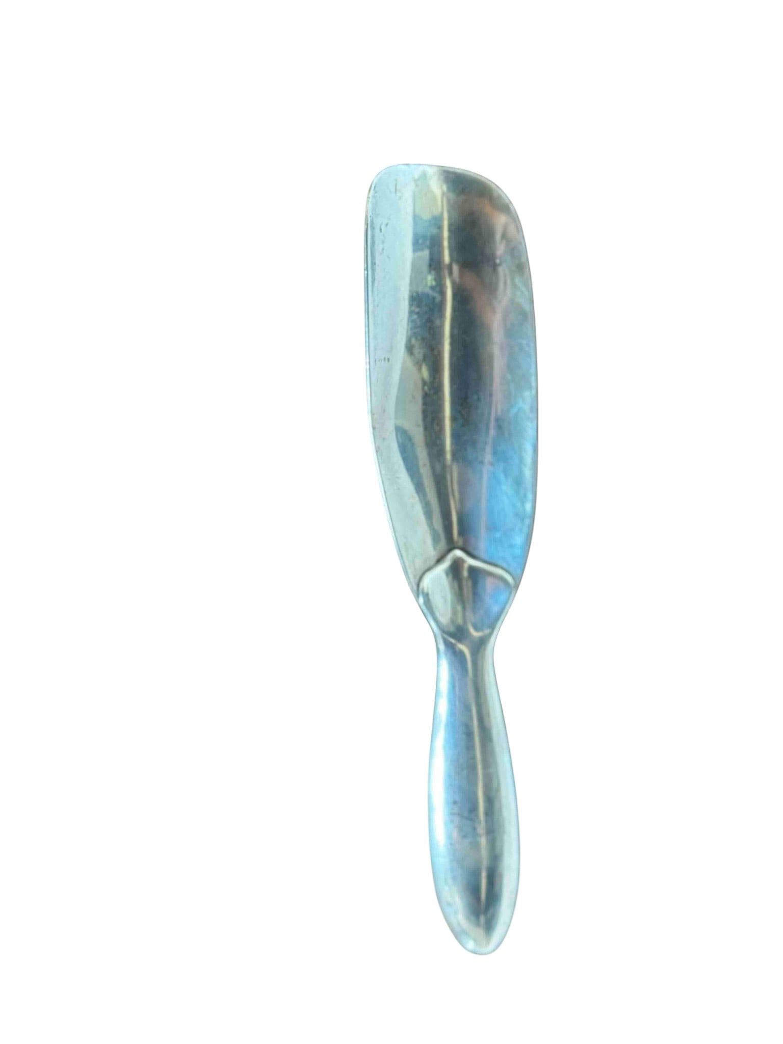 Tiffany & Co Sterling Silver Shoe Horn: A Tiffany & Co. sterling silver shoe horn, likely dating to the early 20th century. This elegant piece features a classic shoe horn form with a rounded bowl and a tapering handle. The underside of the
