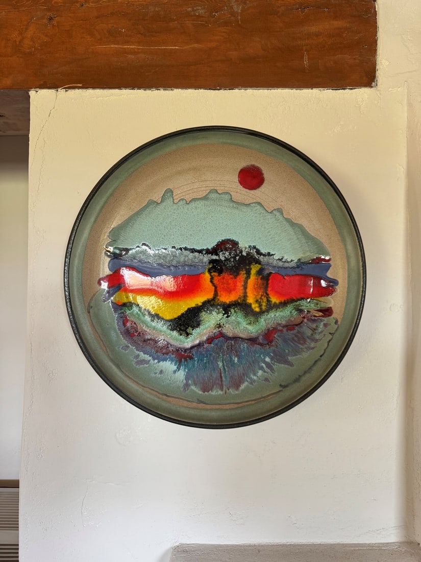 Signed Modernist Studio Pottery Charger, 1984: A striking studio pottery charger, crafted in 1984 by an artist whose signature appears to read 'Mrtha' or 'Mitha'. The charger features a highly glazed, abstract design with a vibrant central