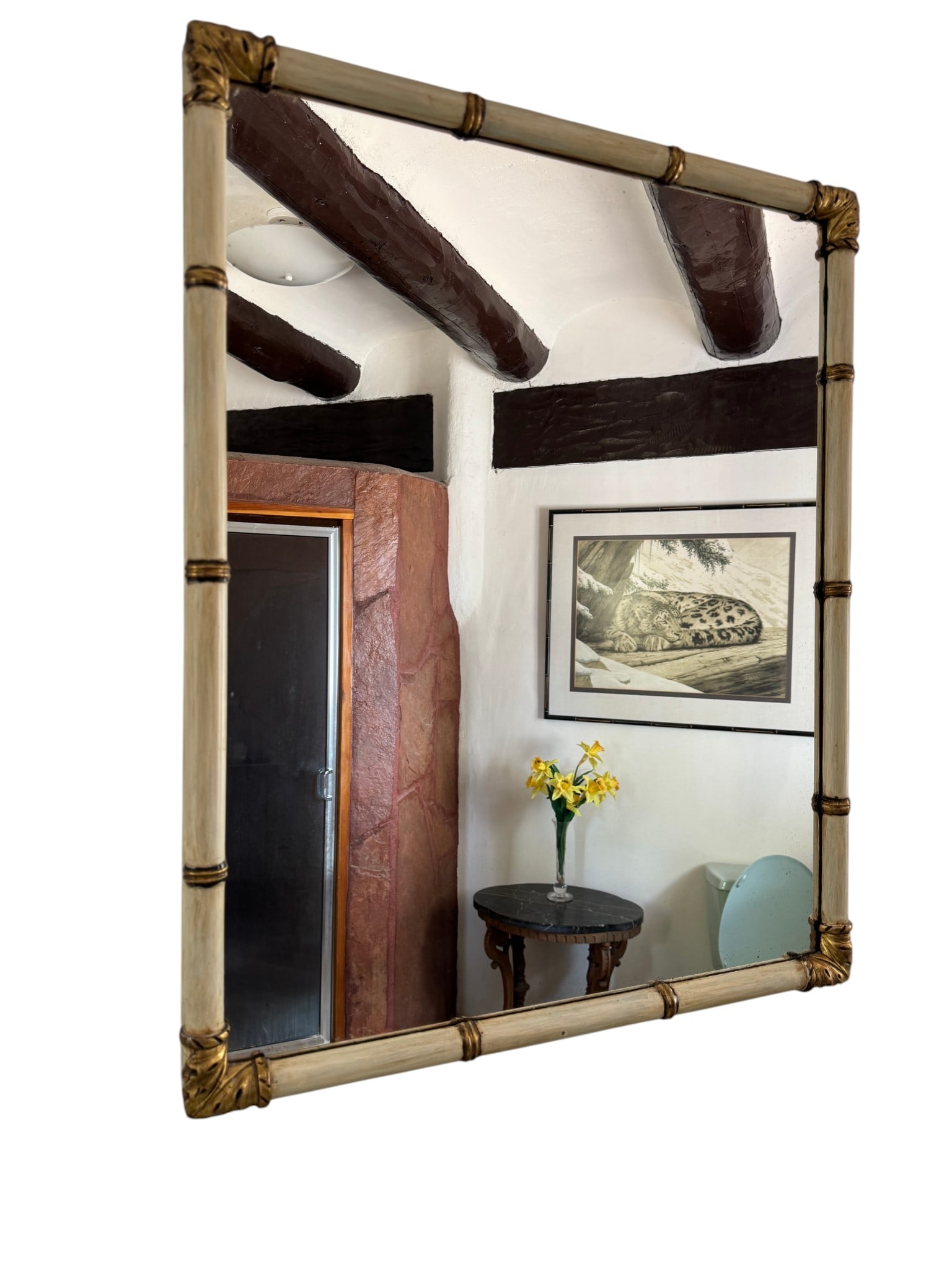 Hollywood Regency Faux Bamboo and Giltwood Wall Mirror: A chic rectangular wall mirror in the Hollywood Regency style, featuring a faux bamboo frame finished in a creamy off-white lacquer with subtle distressing. The corners are adorned with ornate giltwoo