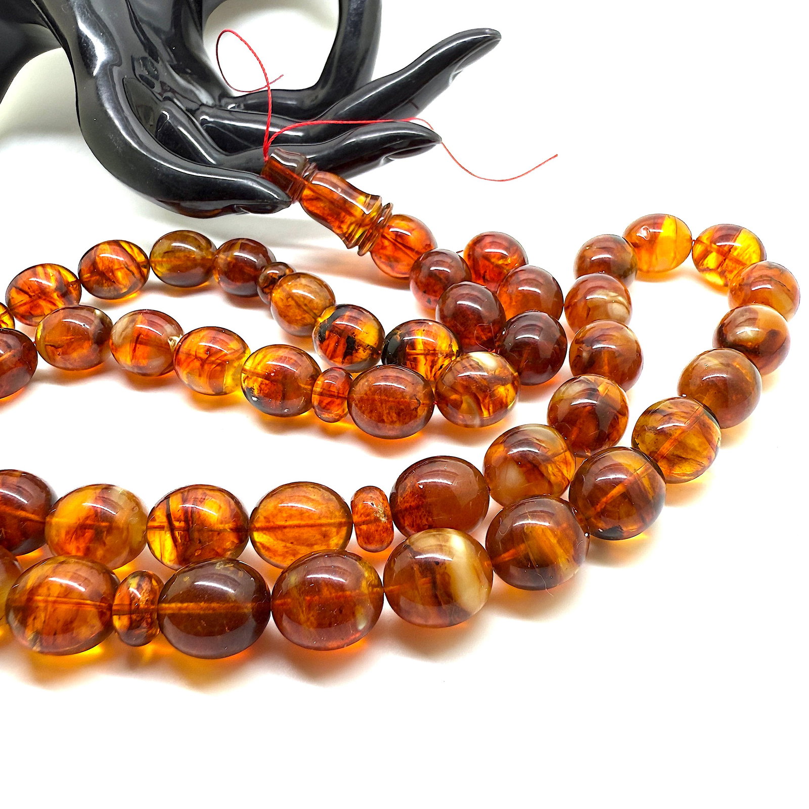 Unique and Magnificent Amber Tesbih made from Olive shaped Amber beads: Title:Unique and Magnificent Amber Tesbih made from Olive shaped Amber beads Metal:None Gemstone:Amber Weight:71.4 g Size:Bead size: 19.0 x 13.0 mm Bead size: 0.748 x 0.512 inches Made of:(Reconstitut