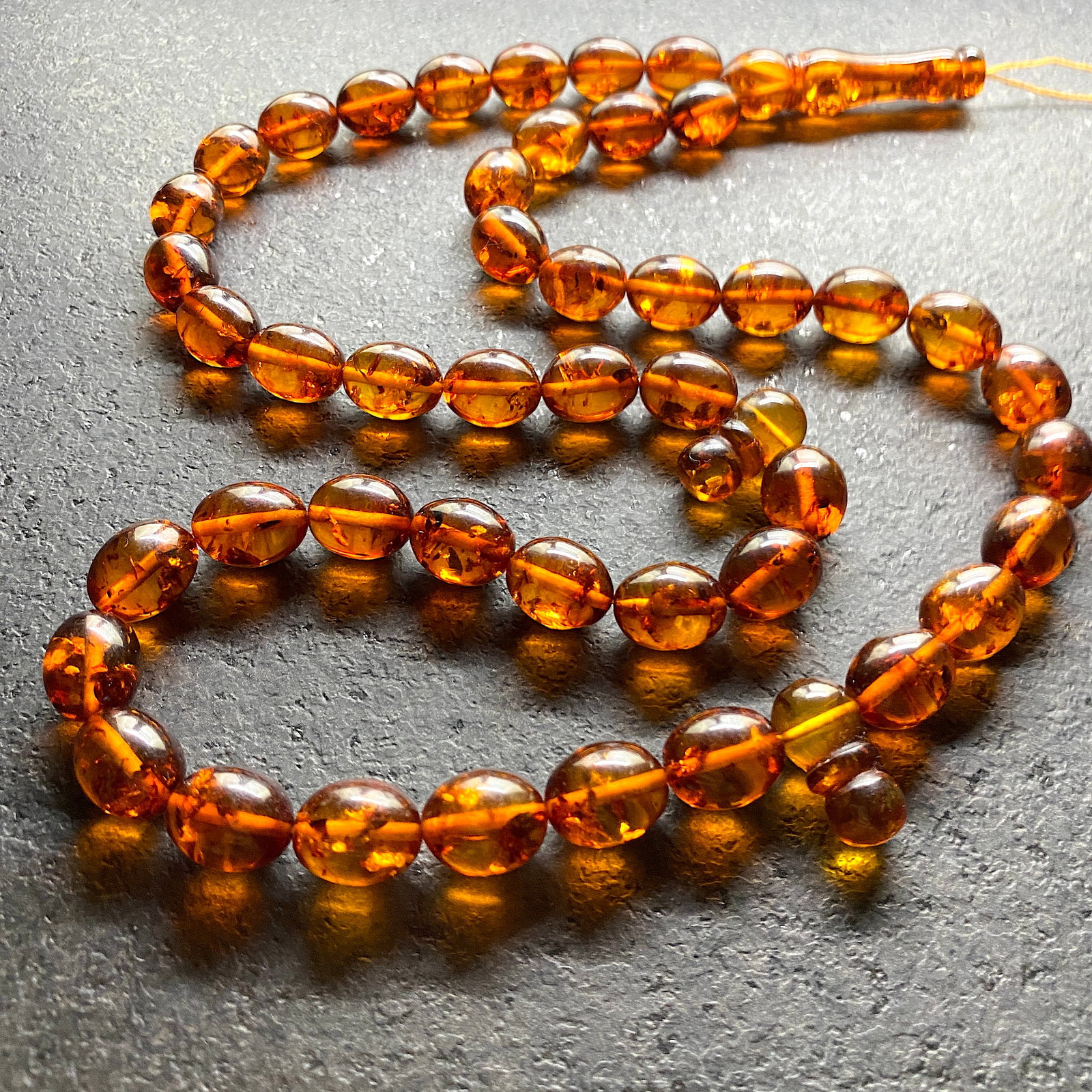 Unique and Impressive Amber Tesbih made from Olive shaped Amber beads: Title:Unique and Impressive Amber Tesbih made from Olive shaped Amber beads Metal:None Gemstone:Amber Weight:42.9 g Size:Bead size: 13.0 x 11.0 mm Bead size: 0.512 x 0.433 inches Made of:(Reconstitute
