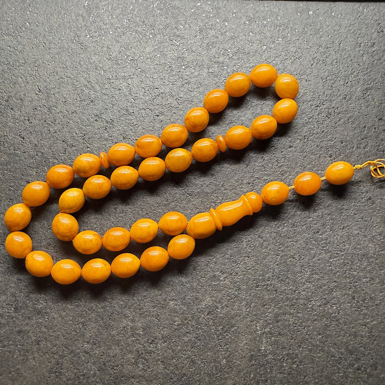 Alluring Amber Tesbih made from Olive shaped Amber beads: Title:Alluring Amber Tesbih made from Olive shaped Amber beads Metal:None Gemstone:Amber Weight:35.3 g Size:Bead size: 11.0 x 13.0 mm Bead size: 0.433 x 0.512 inches Made of:(Reconstituted Amber or