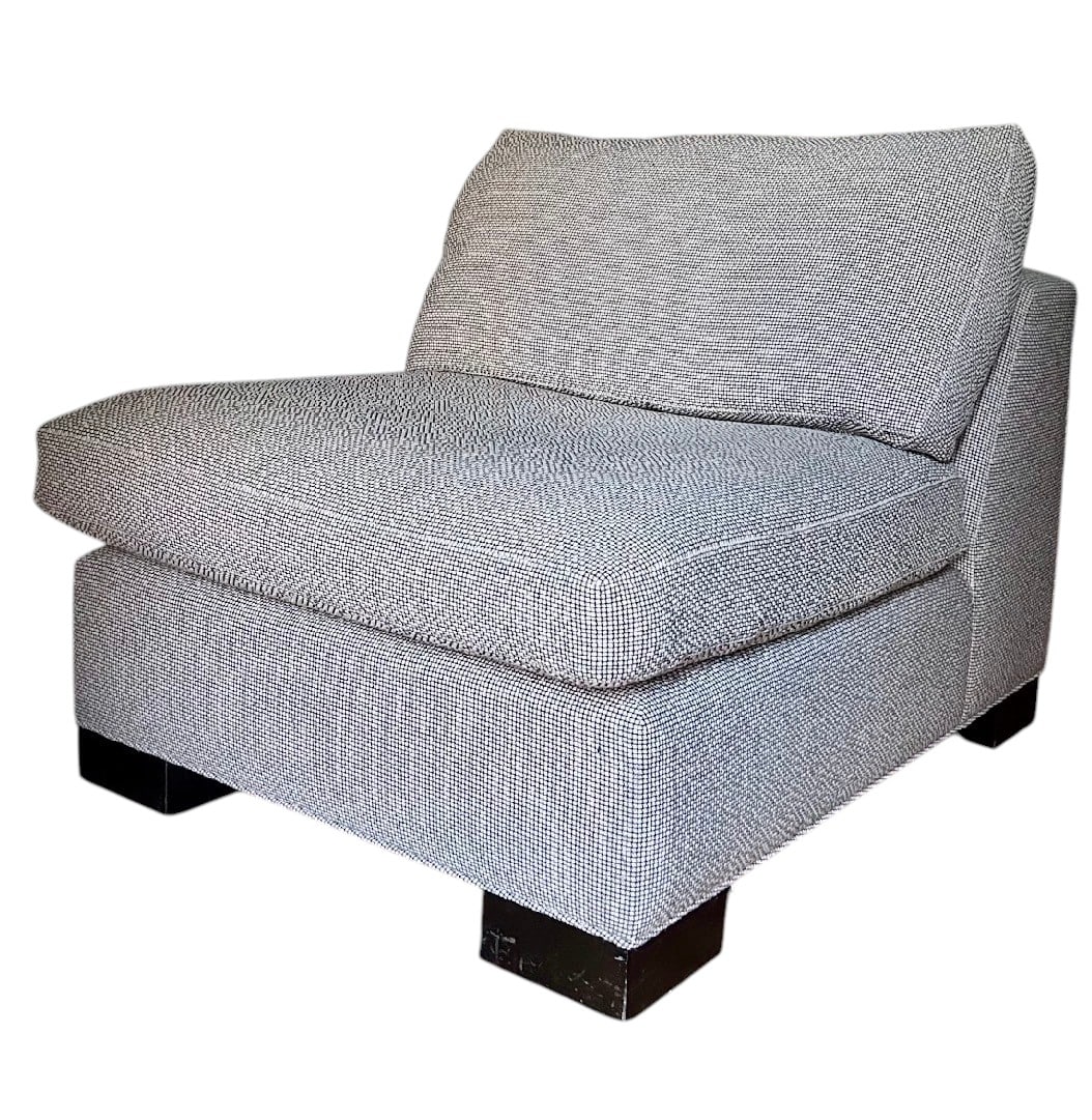 Contemporary Textured Upholstered Armless Chair: This contemporary armless chair features a textured black and off-white woven upholstery, providing a versatile and modern aesthetic. The chair is designed with clean lines, a low profile, and a deep