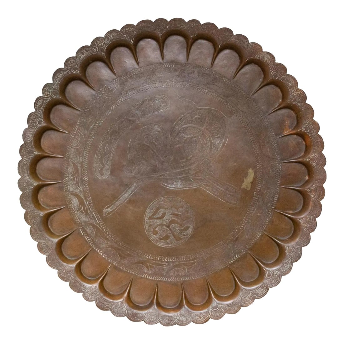 Mid 20th Century Bengal Metal Tray: A round vintage Bengal hammered metal platter with a flower crust rim, with intricate Mughal designs all around with etched designs and a bronze polished finish. Imagine the skilled artisans