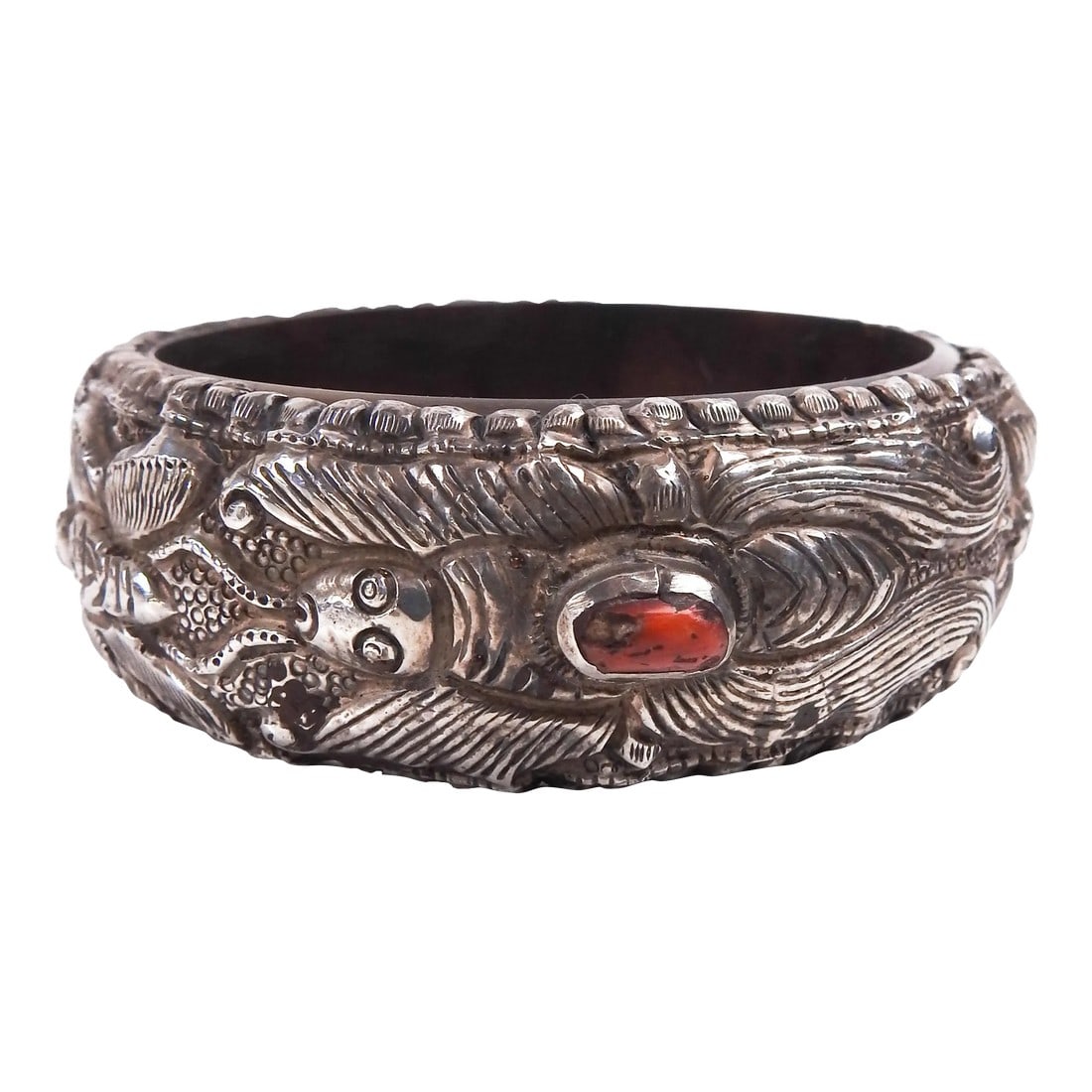 Vintage Tribal Repousse Silver and Coral Bracelet: Vintage sterling silver repousse work bangle with three bezel set red coral pieces. Silver is an old piece which has been firmly formed over newer dense plastic base. Repousse design has insects,