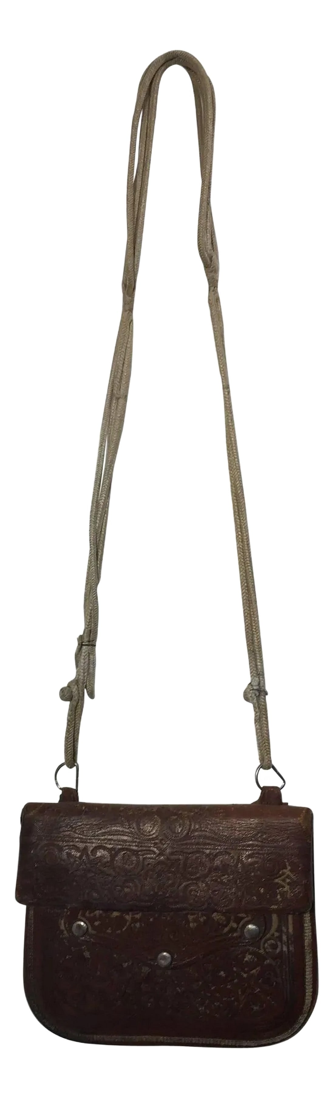 Antique Moroccan Hand Tooled Leather Berber Tribal Shoulder Bag: Antique leather African Moroccan satchel bag with flap decorated with tribal embroideries. Hand-tooled in Marrakech, this is an collectible antique man shoulder slim bag. Merchants in Morocco when tra