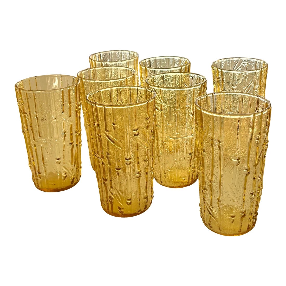 Vintage Golden Glass Bamboo Tumbler Glasses, Set of Eight: Set of eight 12-oz. Tahiti tumbler glasses in a soothing shade of golden yellow. Produced by Anchor Hocking in the 1960s. What a perfect addition to a sunny seaside patio or anywhere one wants to
