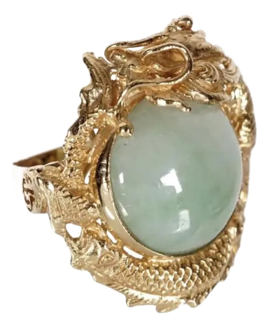 14k Gold and Jade Dragon Ring: Chinese 14k Gold and Jade Dragon Ring. 14k yellow gold ring, reticulated dragon encircling a cabochon jade, 15mm dia. Approx. size 5. Condition: Alterations: Original Condition Unaltered