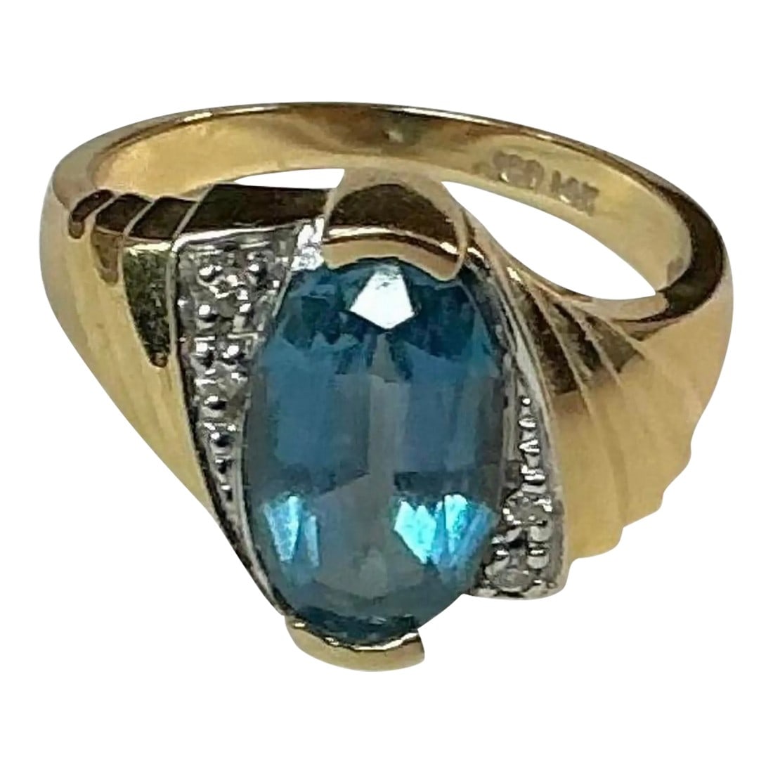 John C Rinker Blue Topaz 14k Yellow Gold and Diamond Ring: 14k yellow gold blue topaz and diamond ring, 4.87 Grams TW. The dimensions of the oval aquamarine are approximately 11.5 mm x 7.5 mm. Approximately 3 carats. Marked 14k. Approximate size 7. Marked JCR