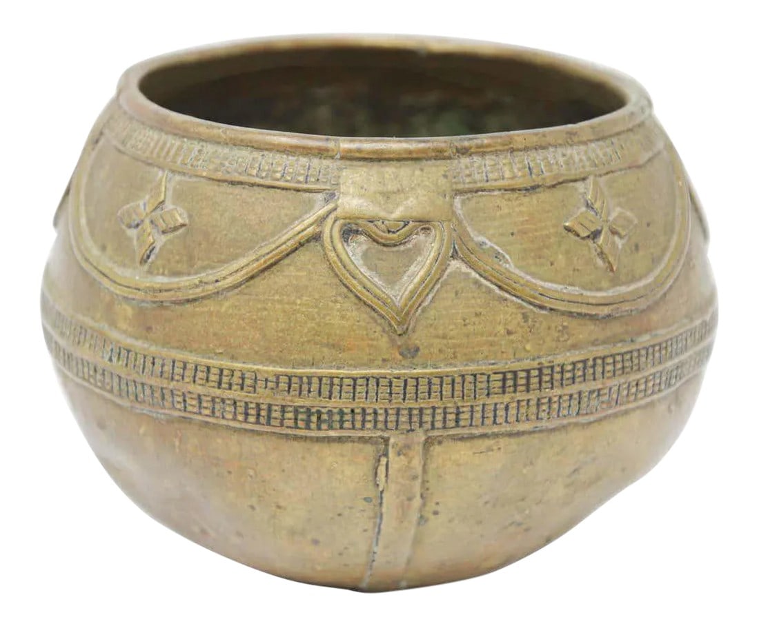 Antique Cast brass Measuring Bowl from Northern India: A medium sized antique cast brass measuring bowl from northern India. High relief casting, bundled rope maker's mark on the bottom. Bronze rice-measuring bowl from Eastern India. Circa 1900