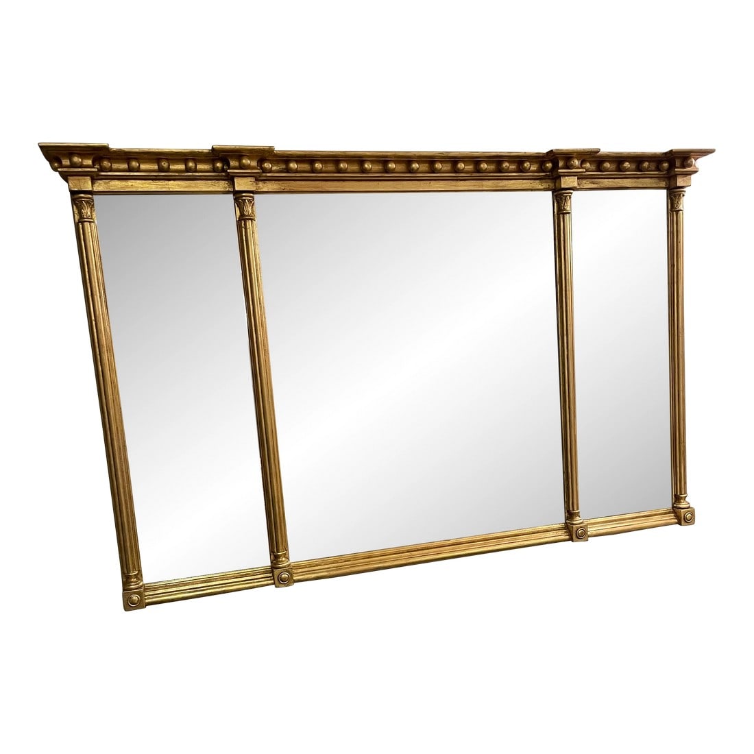 Friedman Brothers Large Traditional Gold Leaf Mirror: Large Friedman Brothers three panel mirror, (58"W x 39"H x 3&3/4"D). The three mirror panels are bevelled glass. The mirror has a complete gold leaf frame. Panels are separated by fluted Corinthian