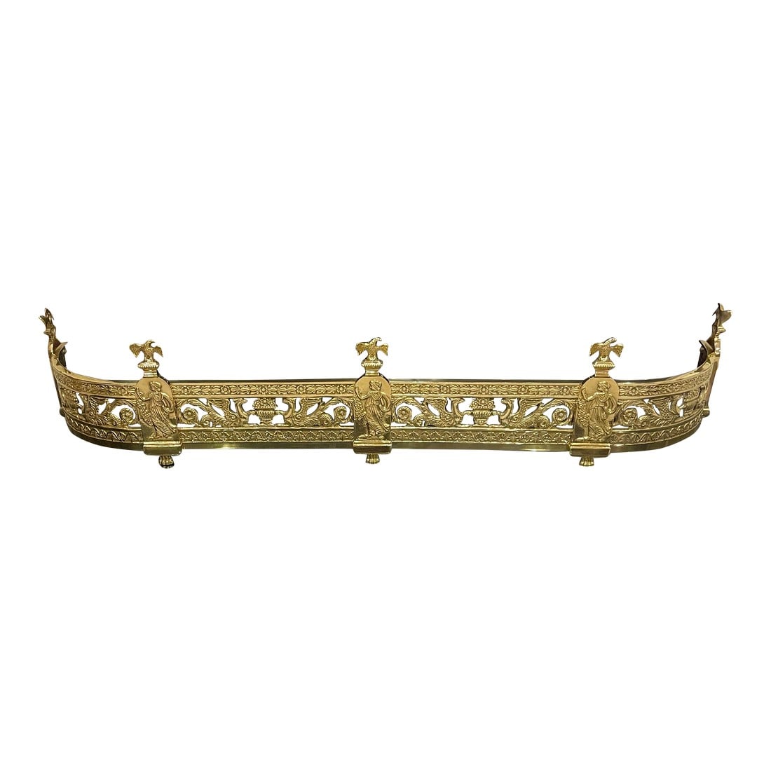 Traditional Design High Sheen Brass Fireplace Fender: Beautiful traditional 55" brass high sheen fireplace fender with rounded corners. The field of the fender features griffins bordered by flowers. There are five posts decorated with a woman carrying fl