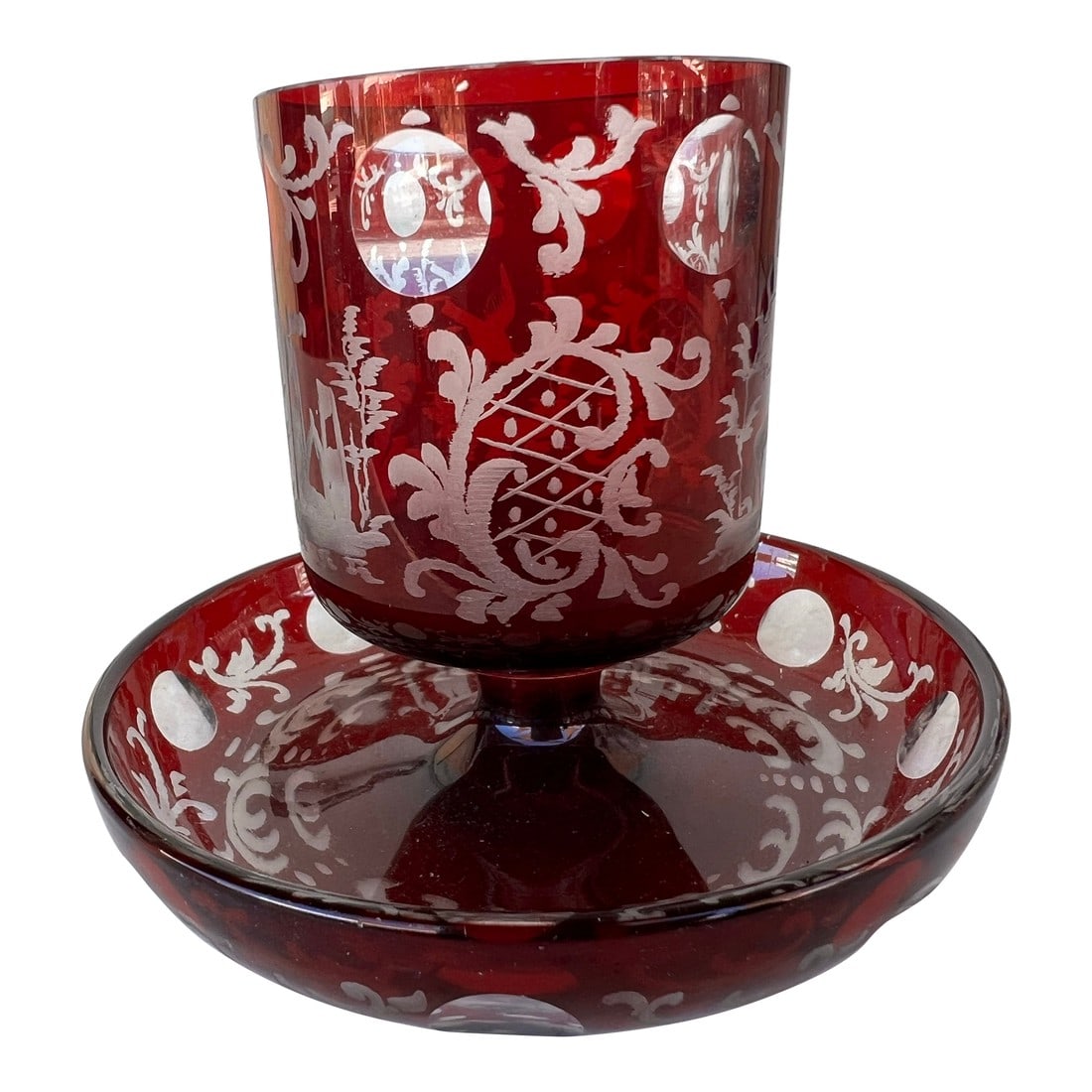 Vintage Early 20th Century Red Crystal Bohemian Glass Footed Holder: This Bohemian Crystal footed holder or vase is ornately decorated with stags, flora, birds, castles landscapes and a decorative diamond pattern. The dark ruby red glass surface is decorated in Baroque