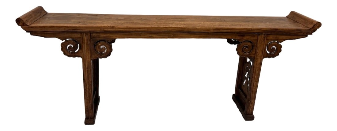 Hand-Carved Chinese Elm Altar Console Table - Cloud Scroll Carvings - Early 20th Century: A beautifully hand-carved Chinese altar console table crafted in solid elm with traditional cloud-scroll detailing. The table features classic upturned "scroll" ends, pierced decorative side panels, a