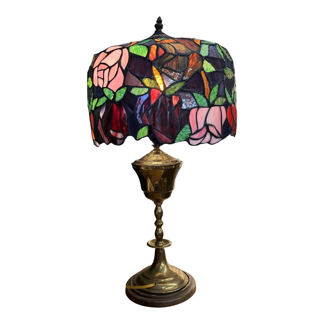 Late 20th Century Tiffany-Style Stained Glass Lamp: This vintage lamp's primary visual feature is the vivid floral design of the stained glass shade, finely hand-wrought; condition excellent. It is supported by a brass body and wooden base with felted