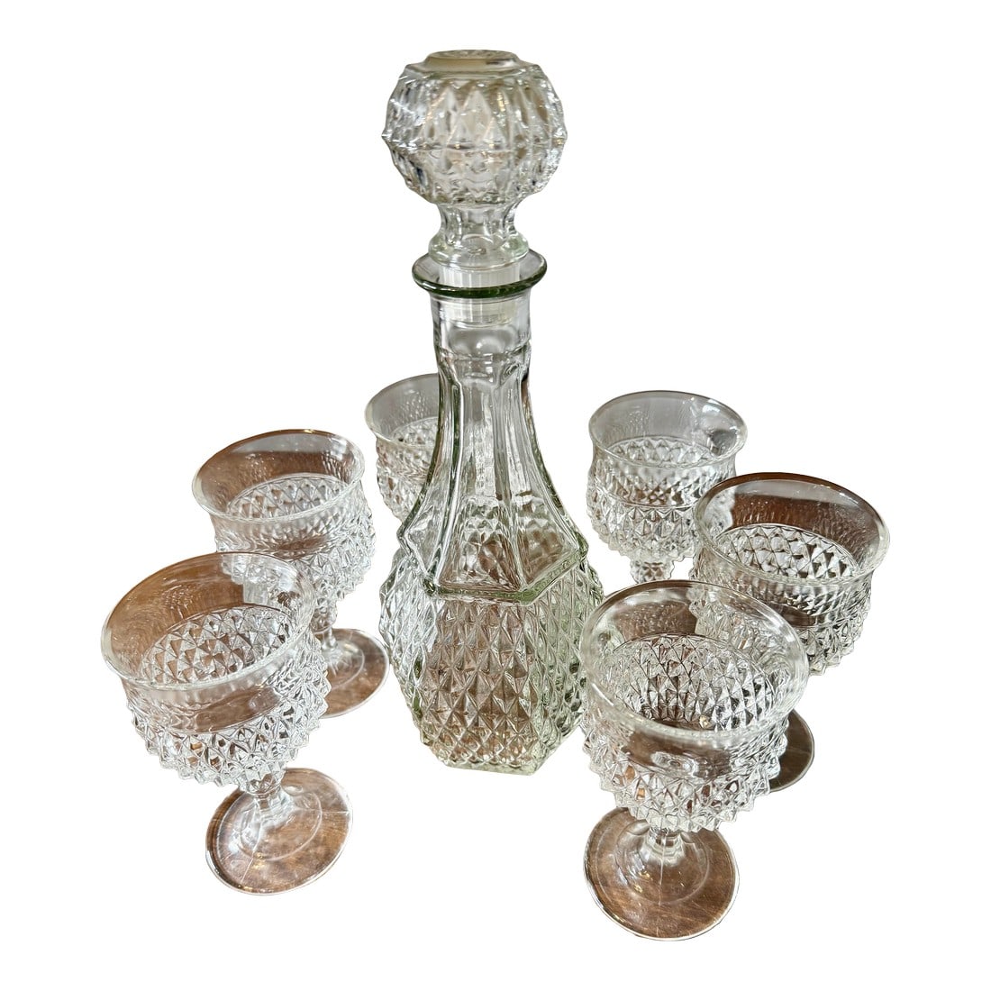 Early 20th Century Glass Decanter Set With Six Stemmed Goblets: The Art Deco decanter and glassware set appears to be manufactured in the 1920's from Europe. This set is not only beautiful but also a wonderful glimpse into the design aesthetics of the 20th